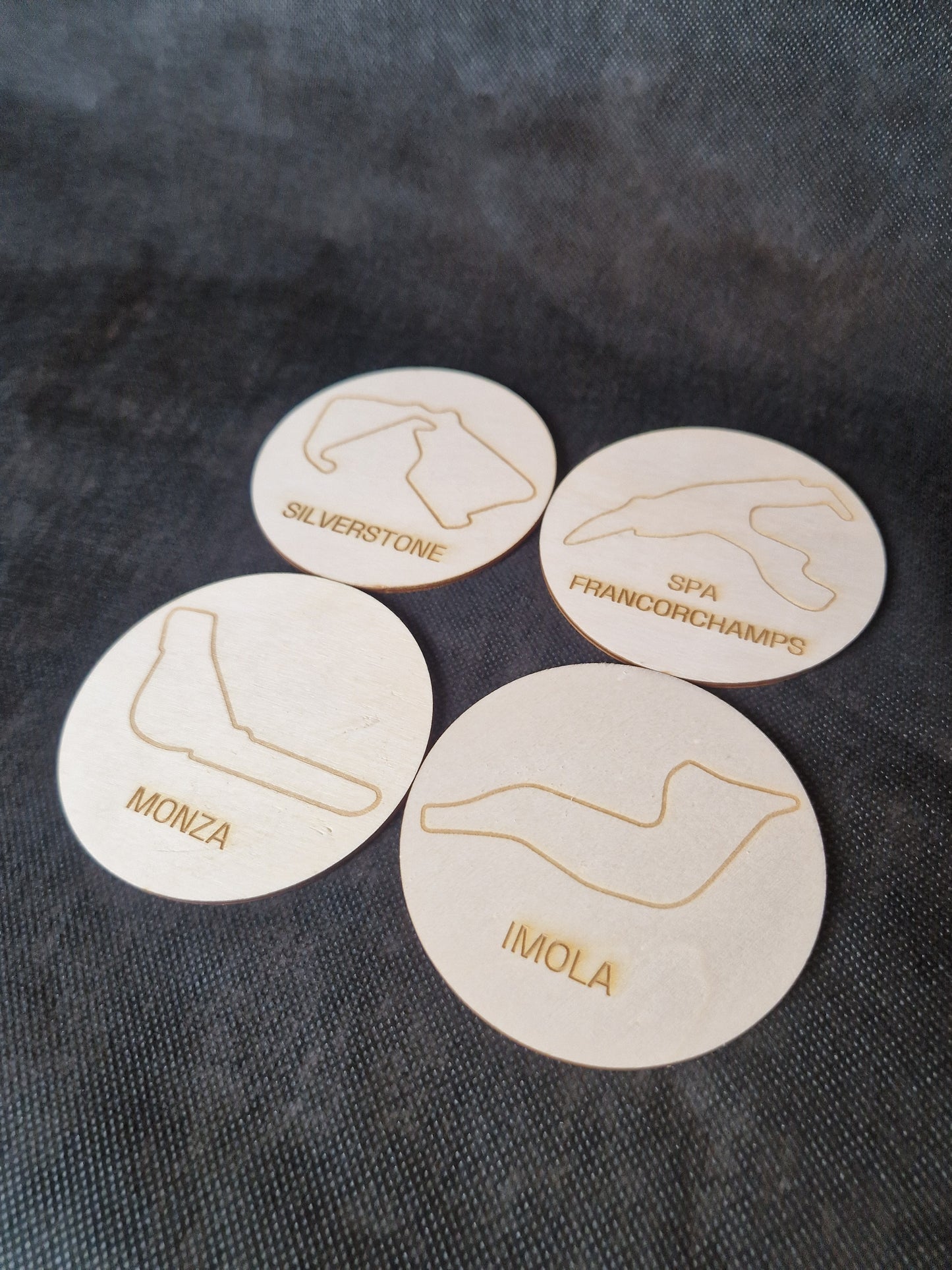 Wooden coaster set with laser cut race track designs