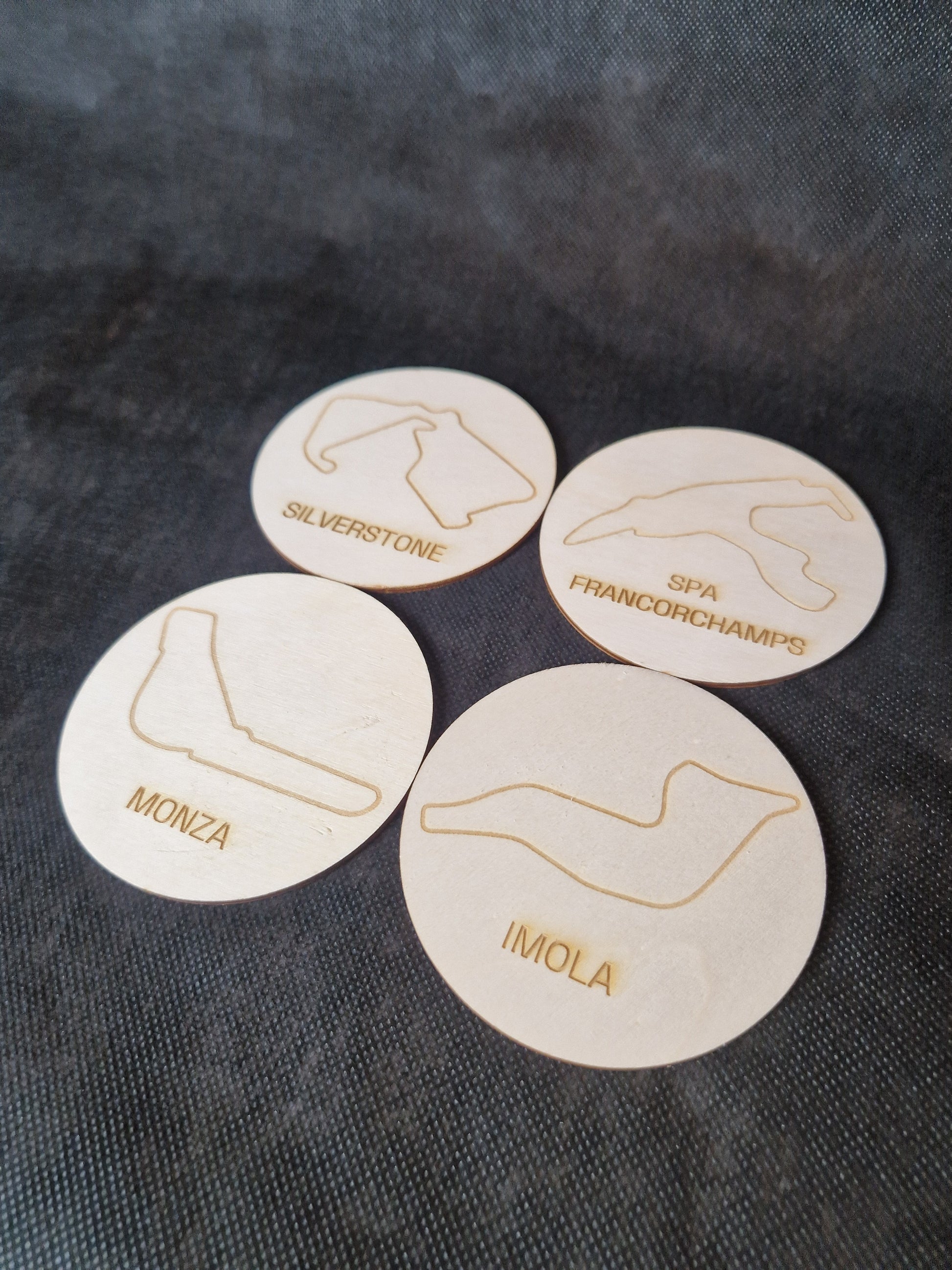 Wooden coaster set with laser cut race track designs