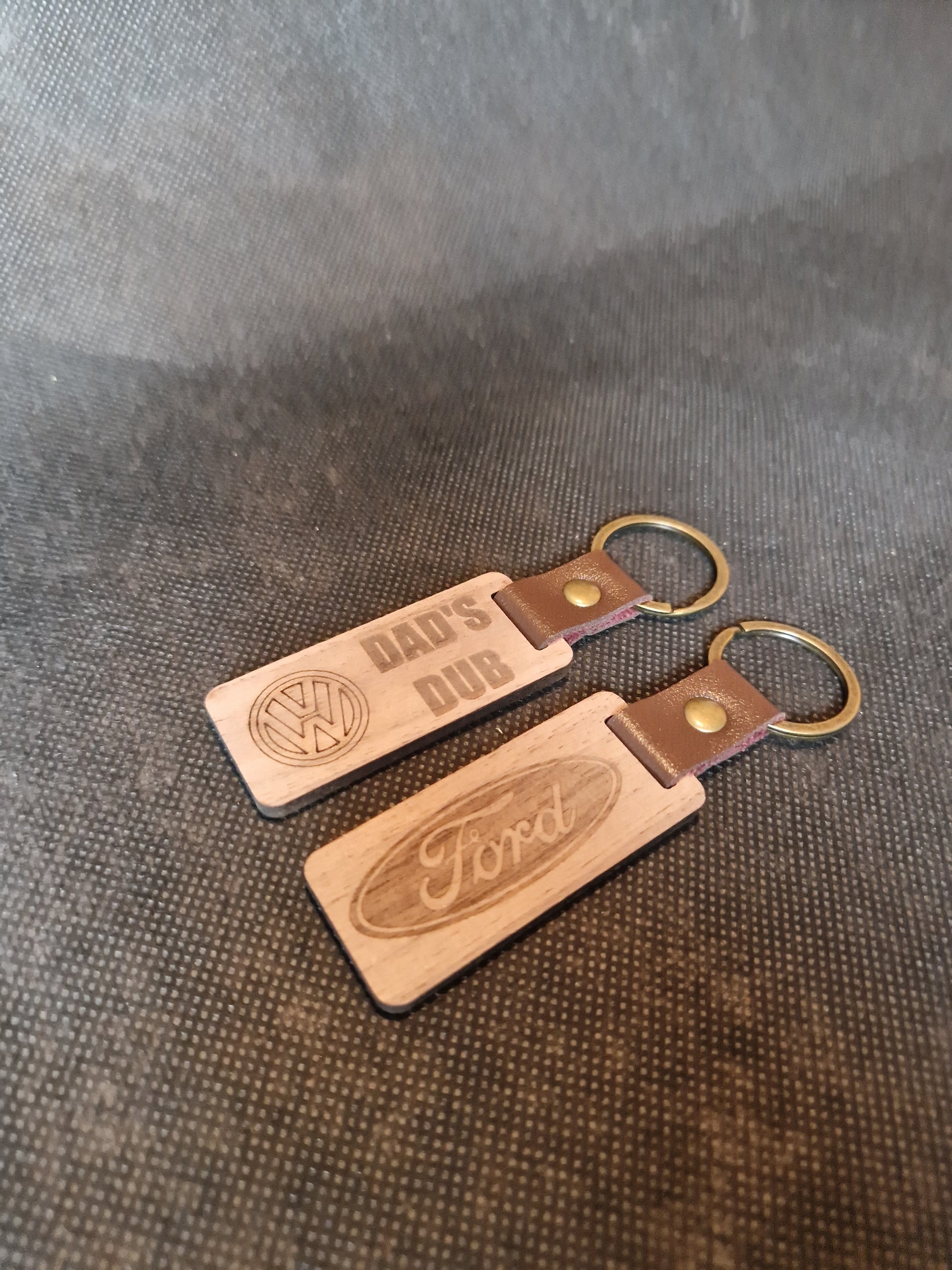 Personalized wooden keyring with laser engraved design and durable metal ring attachment