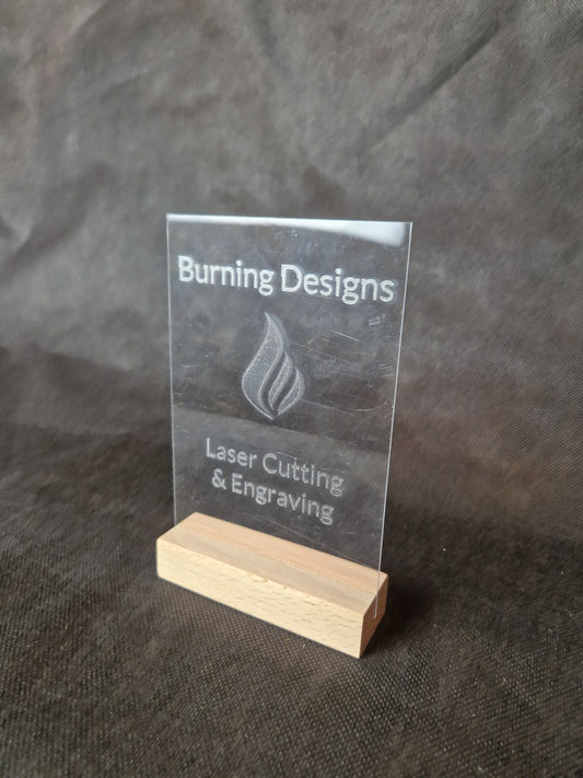 Clear acrylic display stand with custom laser engraved text and modern design