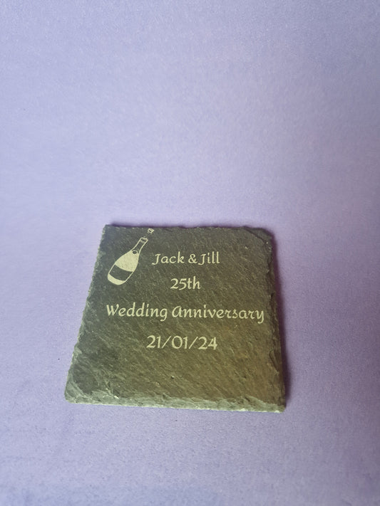 Natural black slate drink coaster with custom laser engraved design and protective feet
