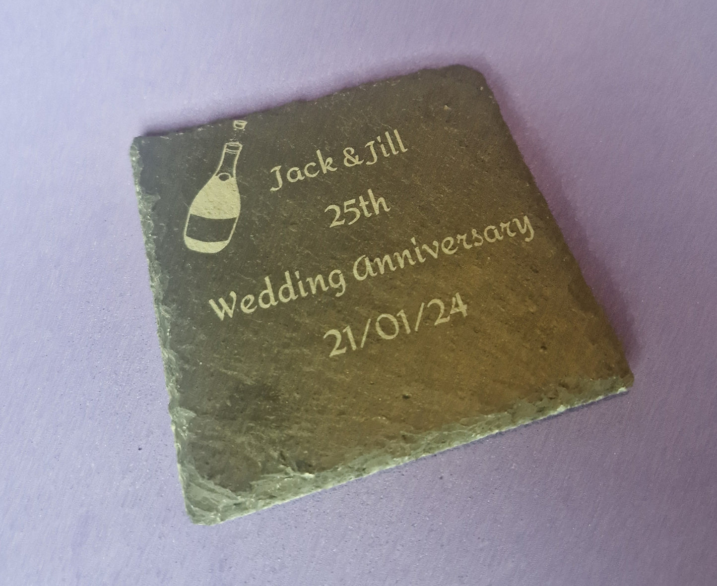 Natural black slate drink coaster with custom laser engraved design and protective feet