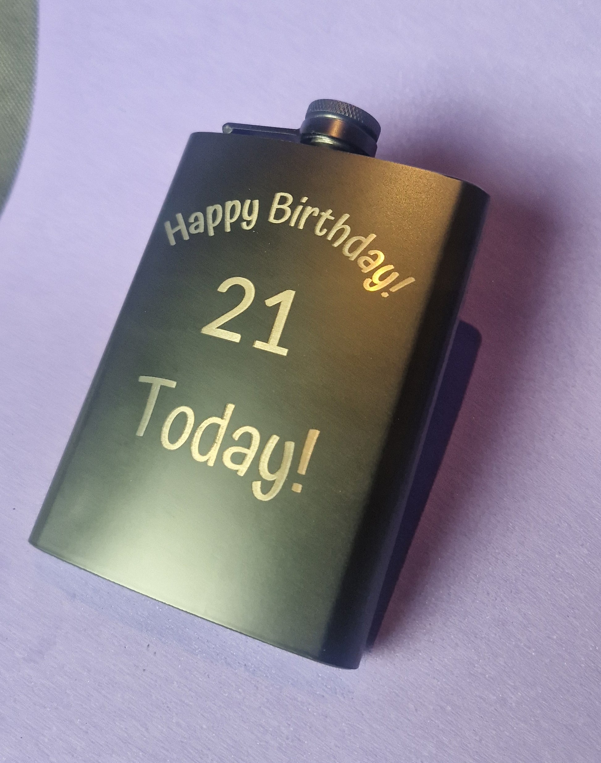 Stainless steel hip flask with personalized laser engraved message and brushed metal finish