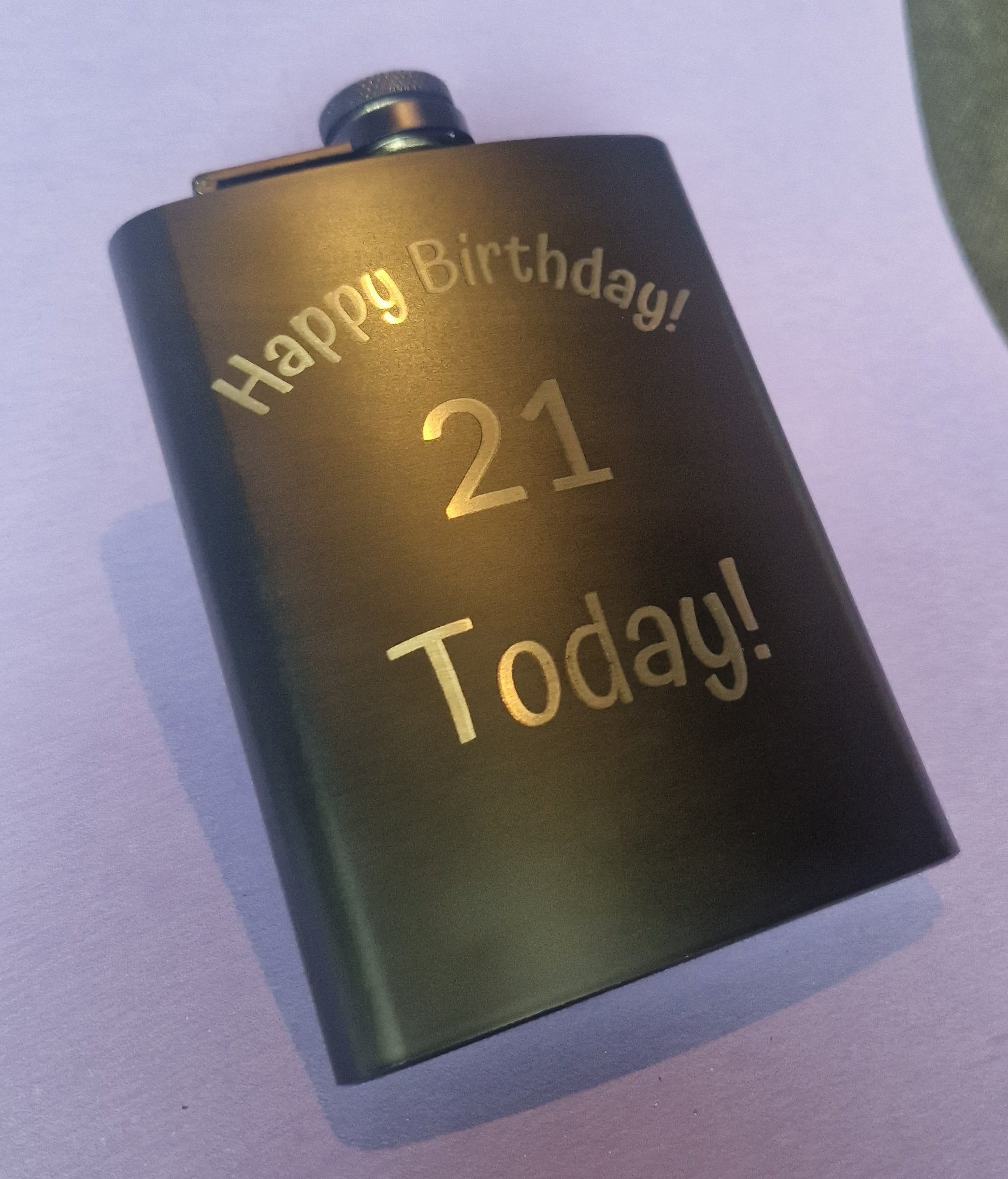 Stainless steel hip flask with personalized laser engraved message and brushed metal finish