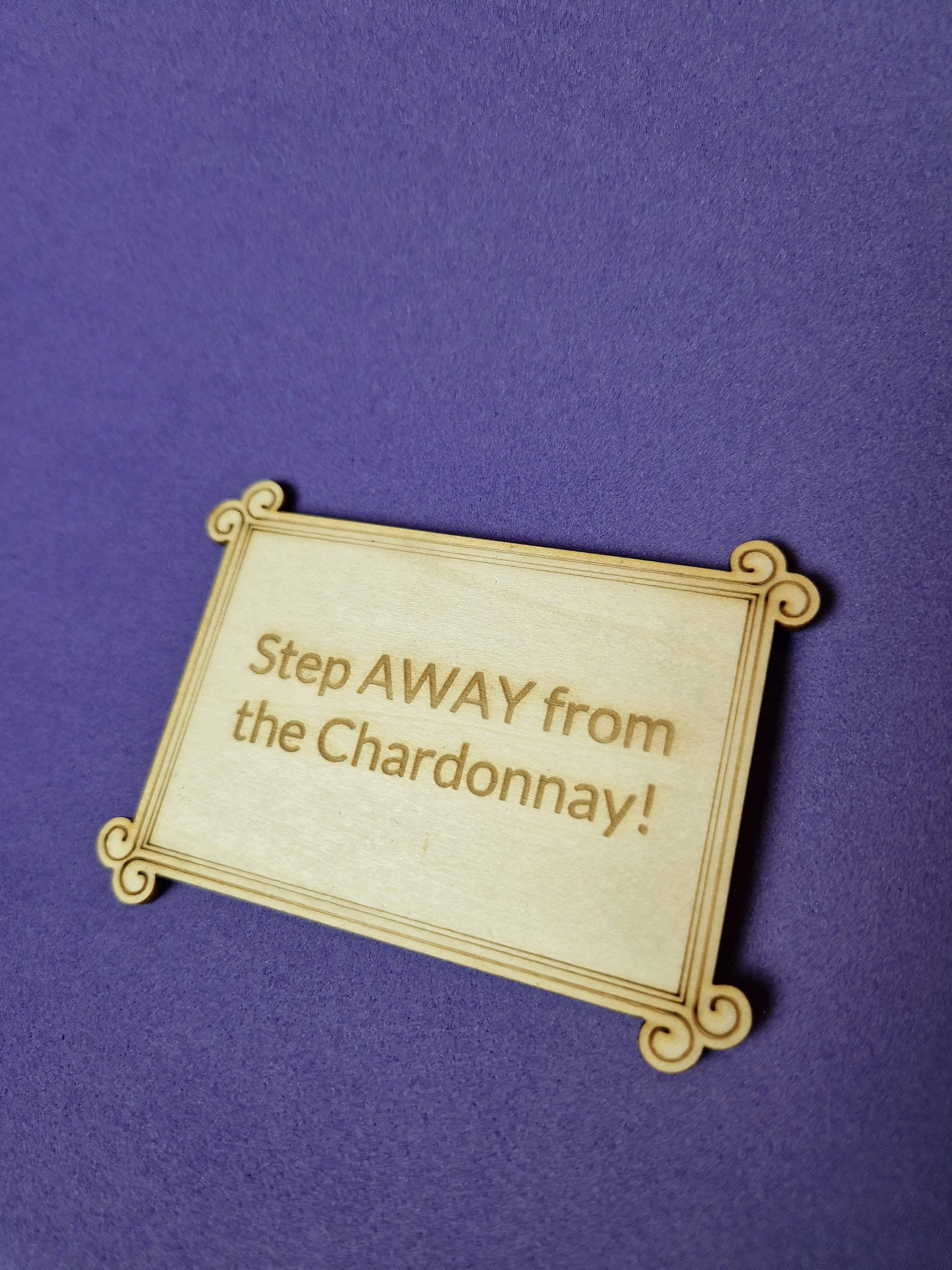 Custom wooden fridge magnet with laser engraved design and magnetic backing