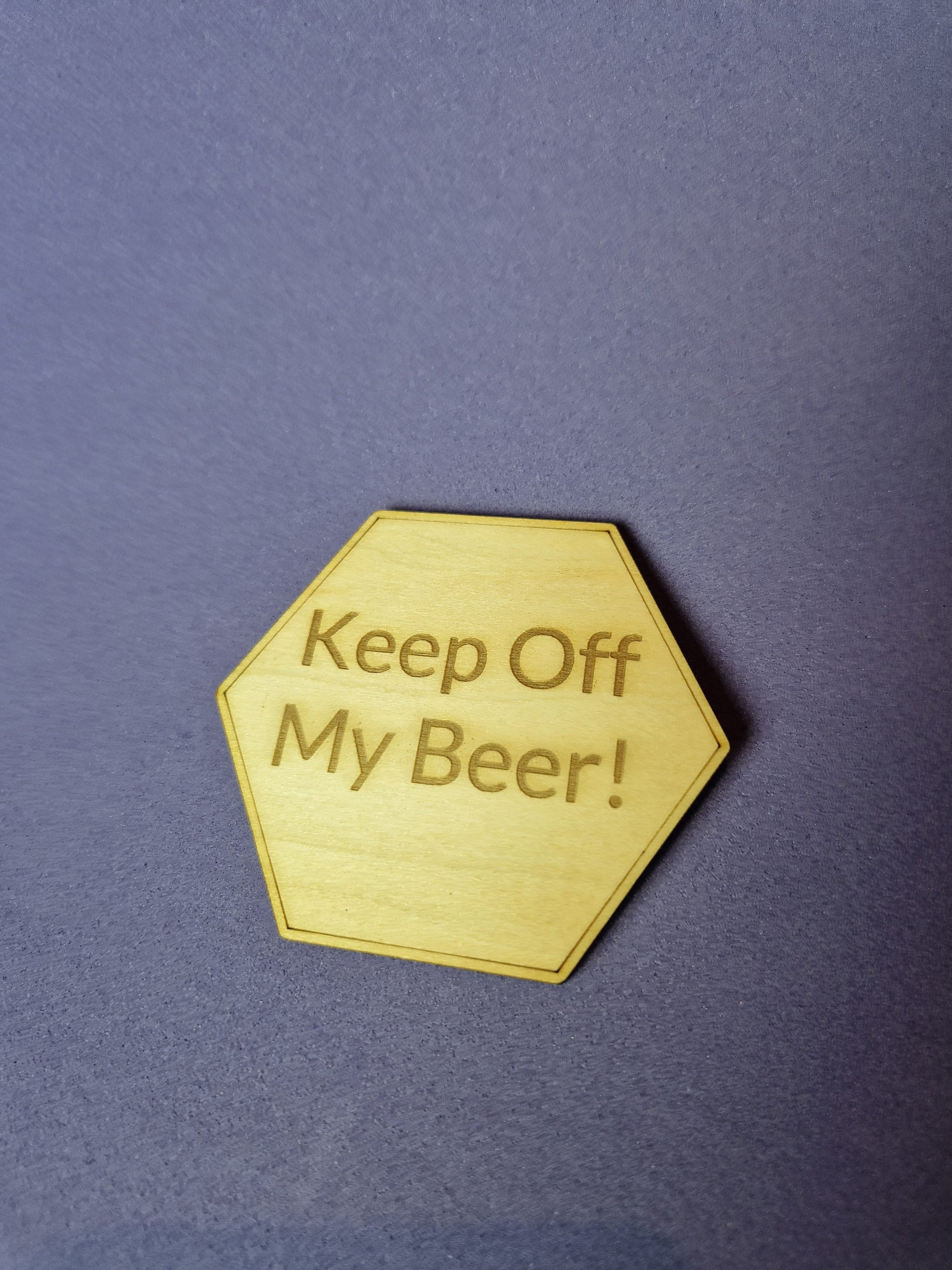 Custom wooden fridge magnet with laser engraved design and magnetic backing