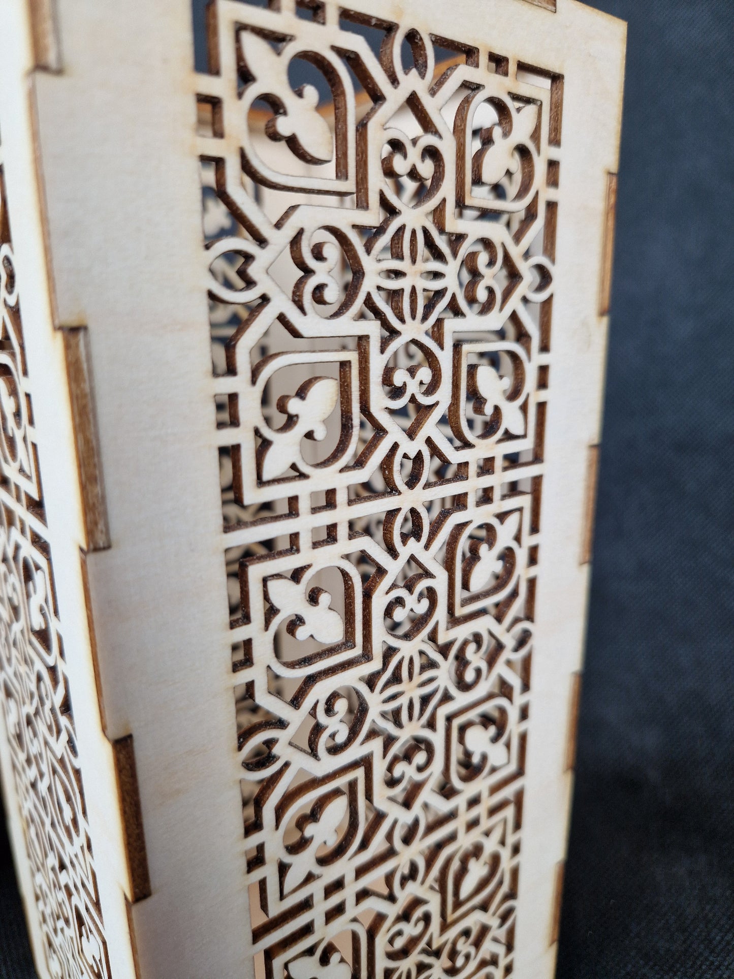 Decorative wooden lantern with intricate laser cut patterns and tea light holder
