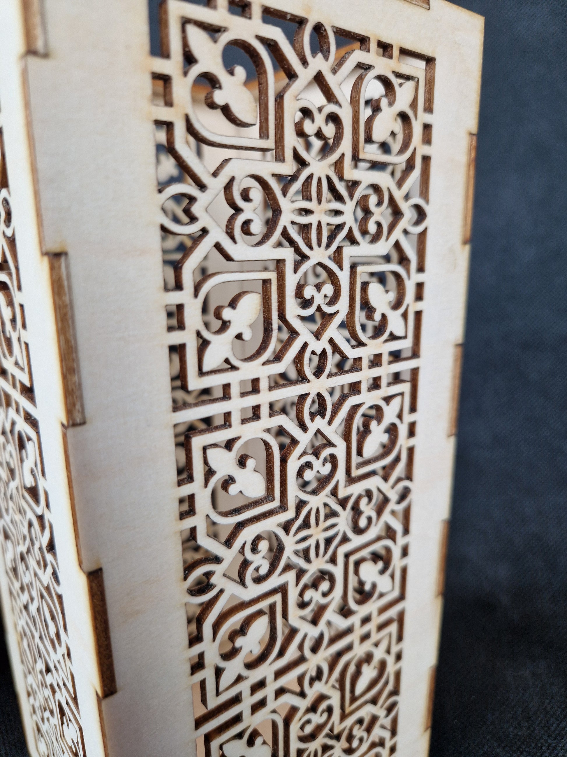 Decorative wooden lantern with intricate laser cut patterns and tea light holder