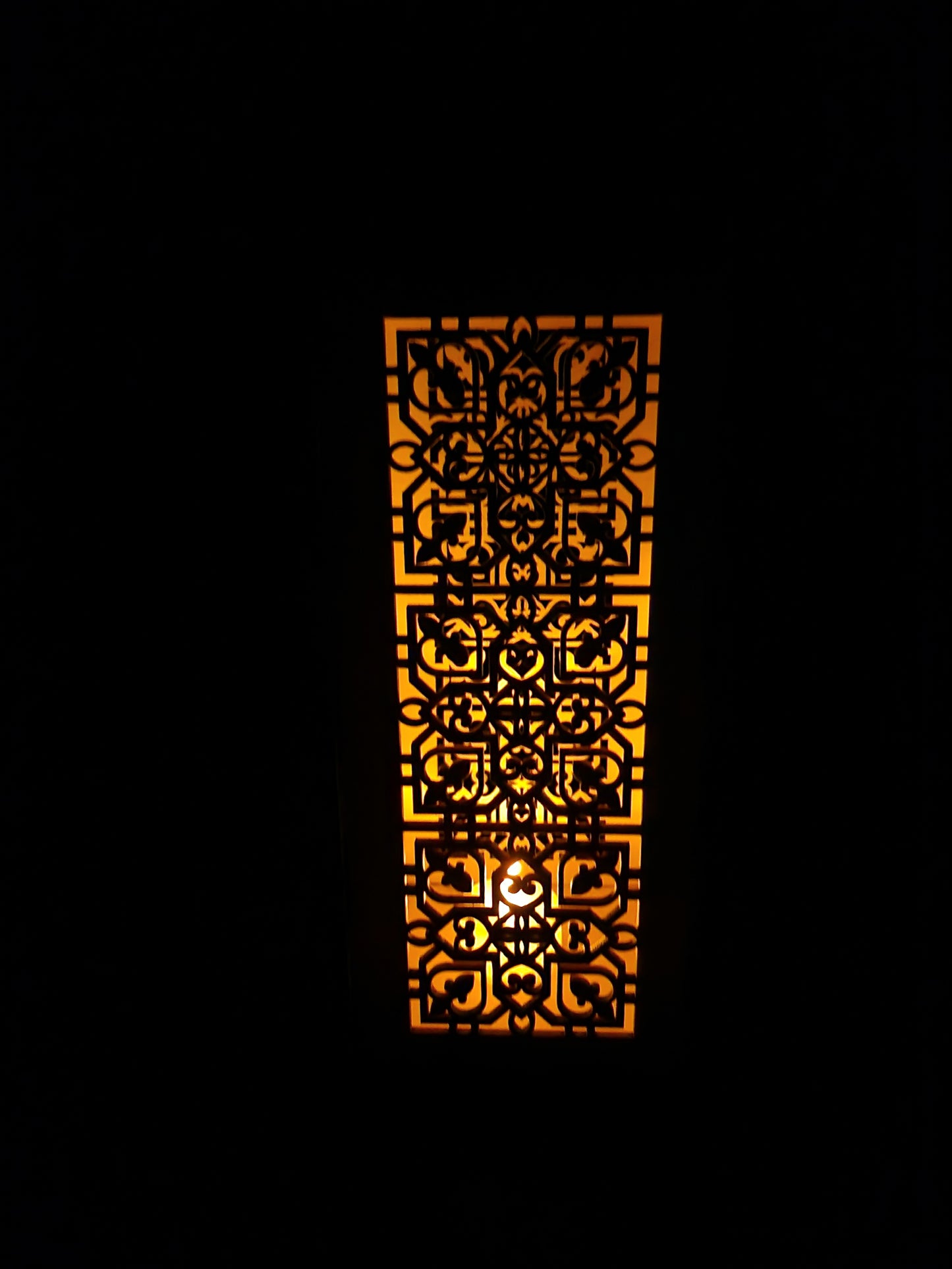 Decorative wooden lantern with intricate laser cut patterns and tea light holder