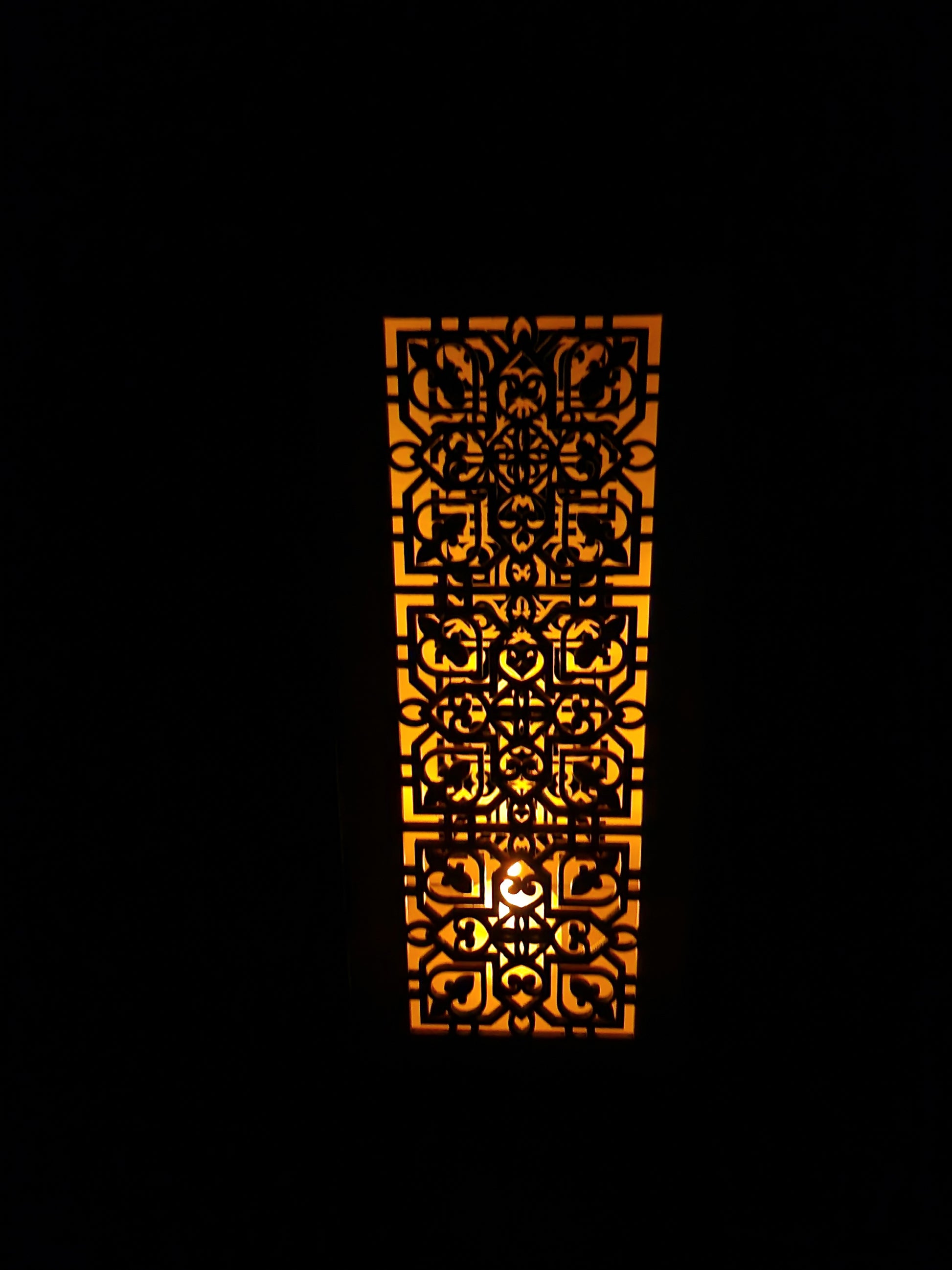 Decorative wooden lantern with intricate laser cut patterns and tea light holder