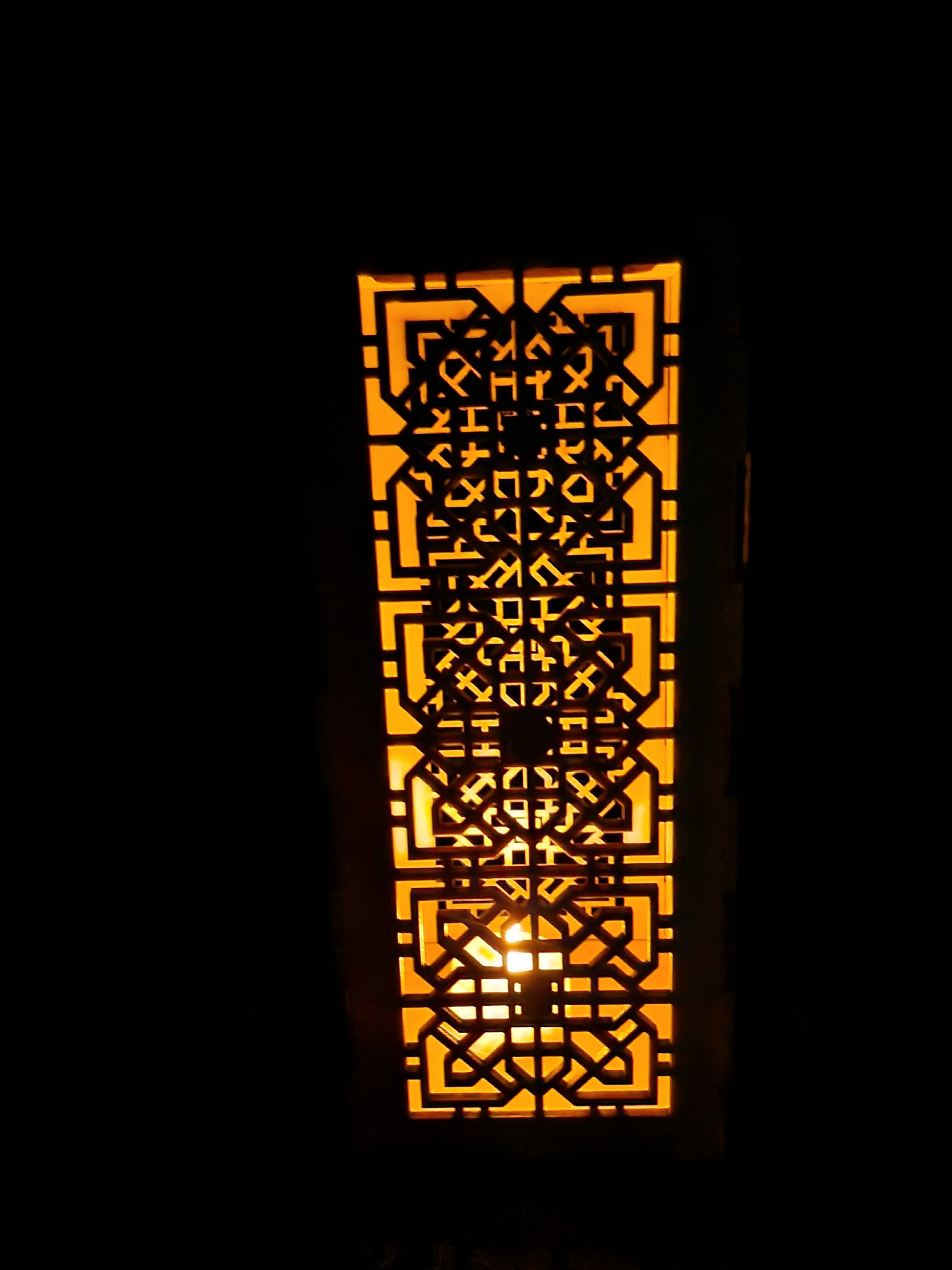 Decorative wooden lantern with intricate laser cut patterns and tea light holder