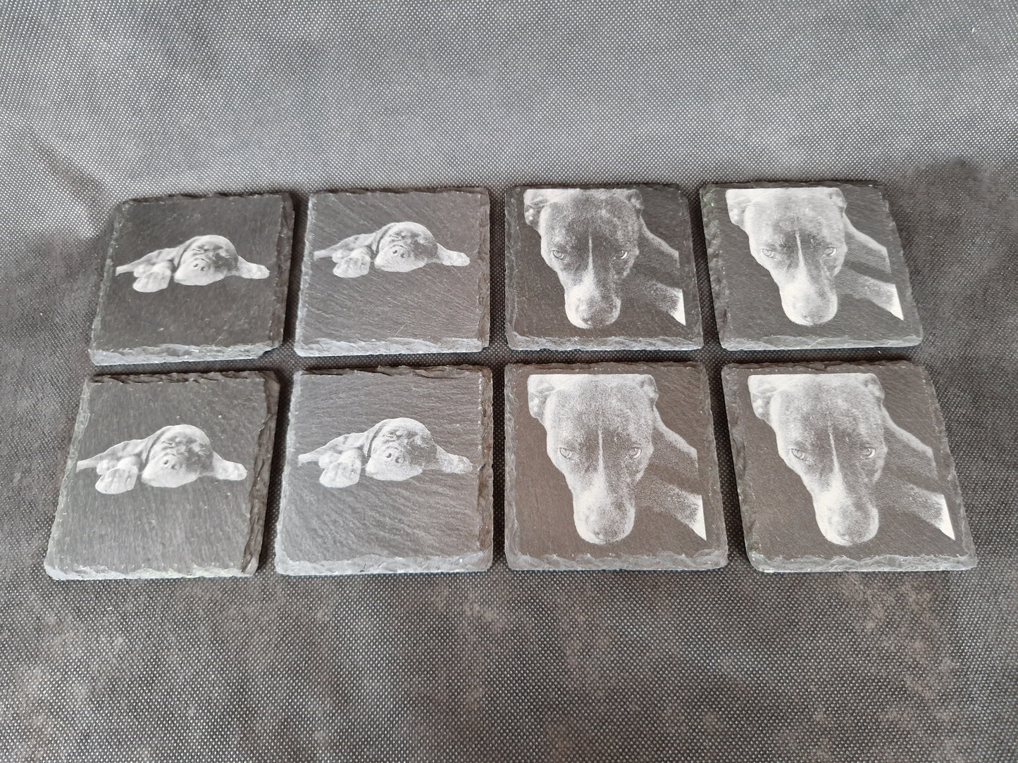 Natural black slate drink coaster with custom laser engraved design and protective feet