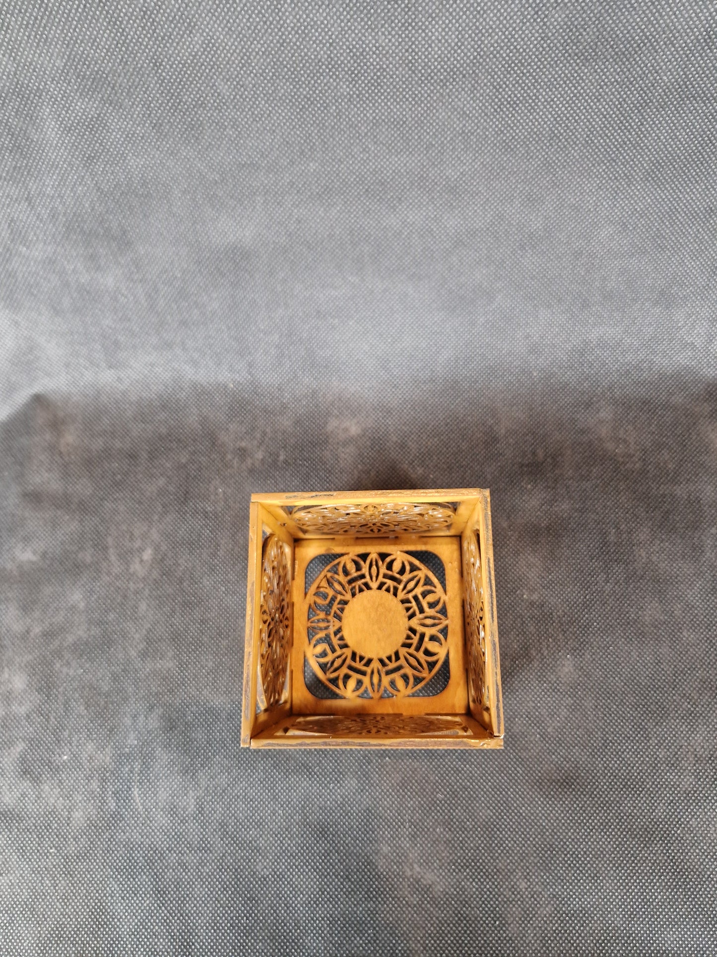 Decorative wooden candle holder with intricate laser cut pattern