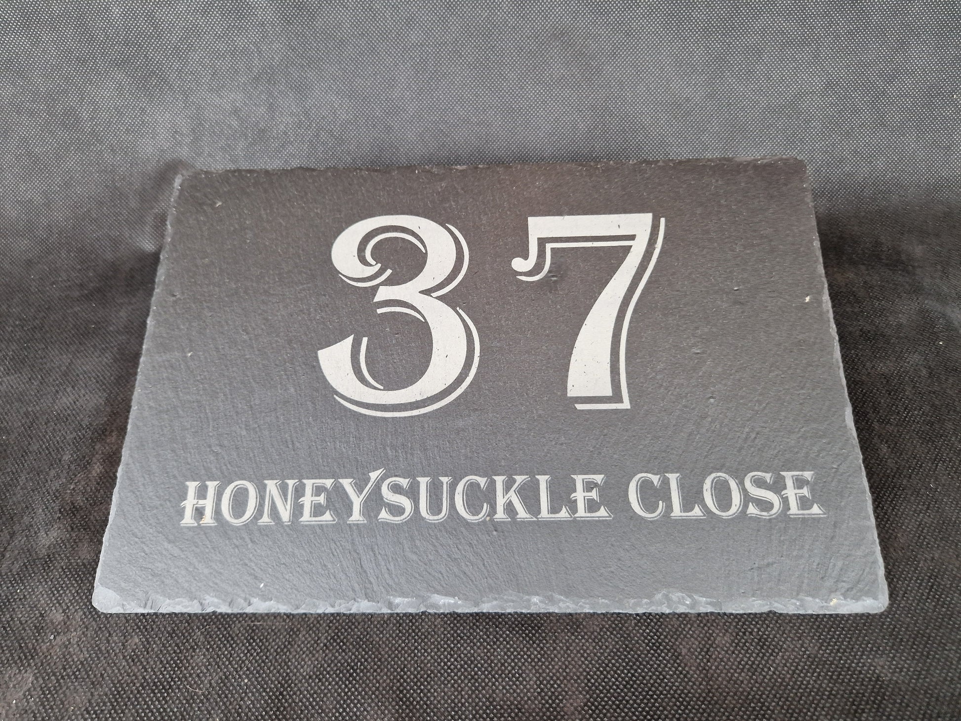 Black slate A4 house sign with custom laser engraved family name and house number