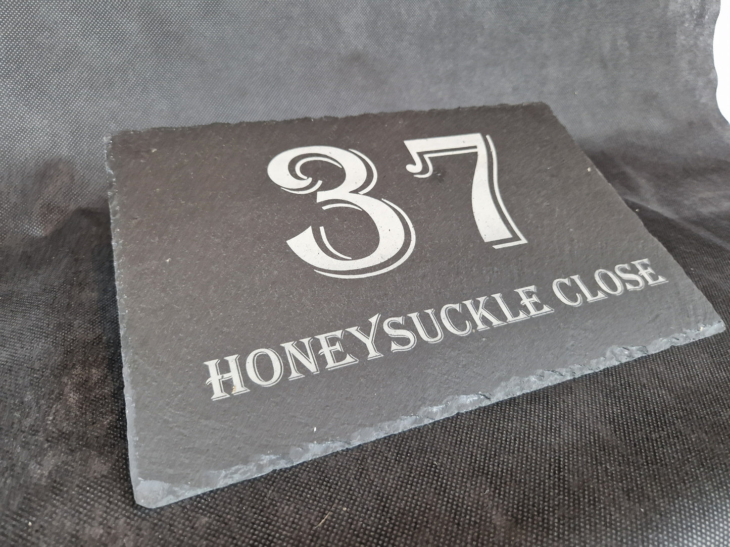 Black slate A4 house sign with custom laser engraved family name and house number