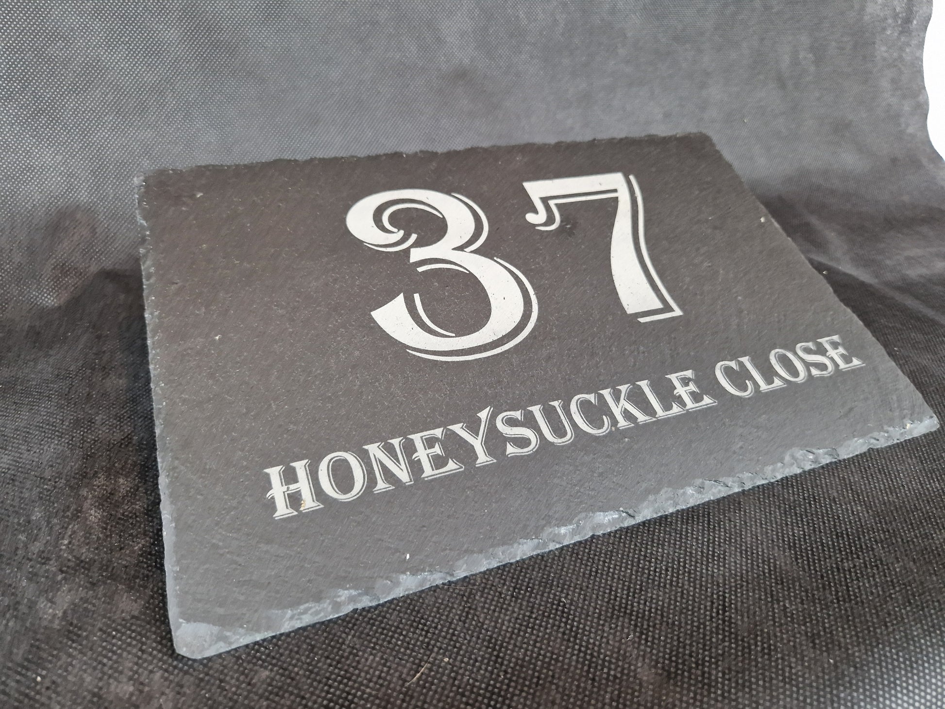 Black slate A4 house sign with custom laser engraved family name and house number