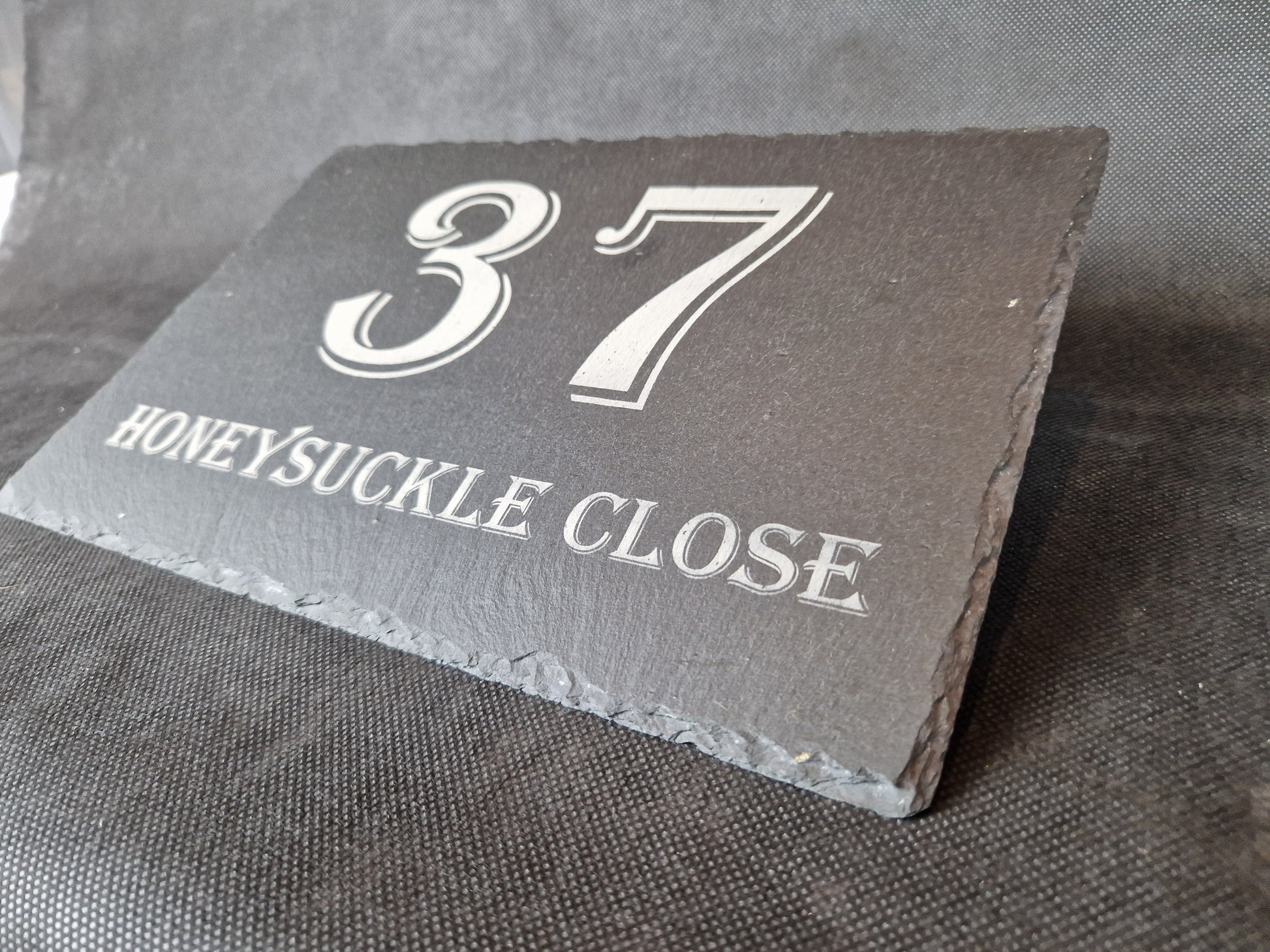 Black slate A4 house sign with custom laser engraved family name and house number