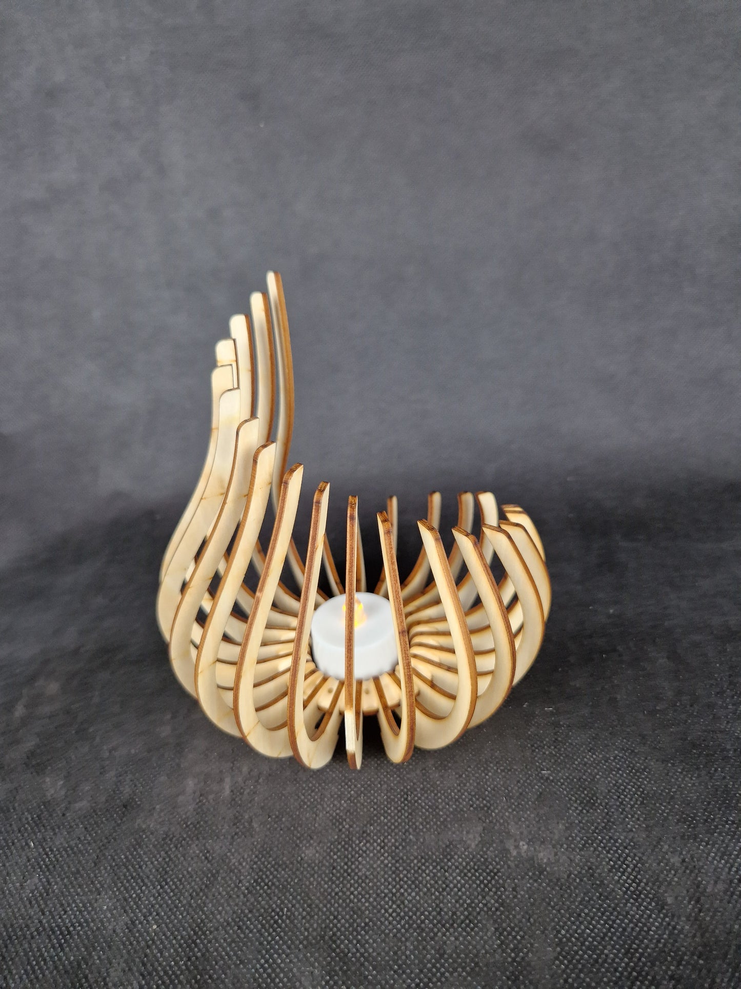 Modern geometric wooden tea light holder with intricate laser cut pattern creating light shadows
