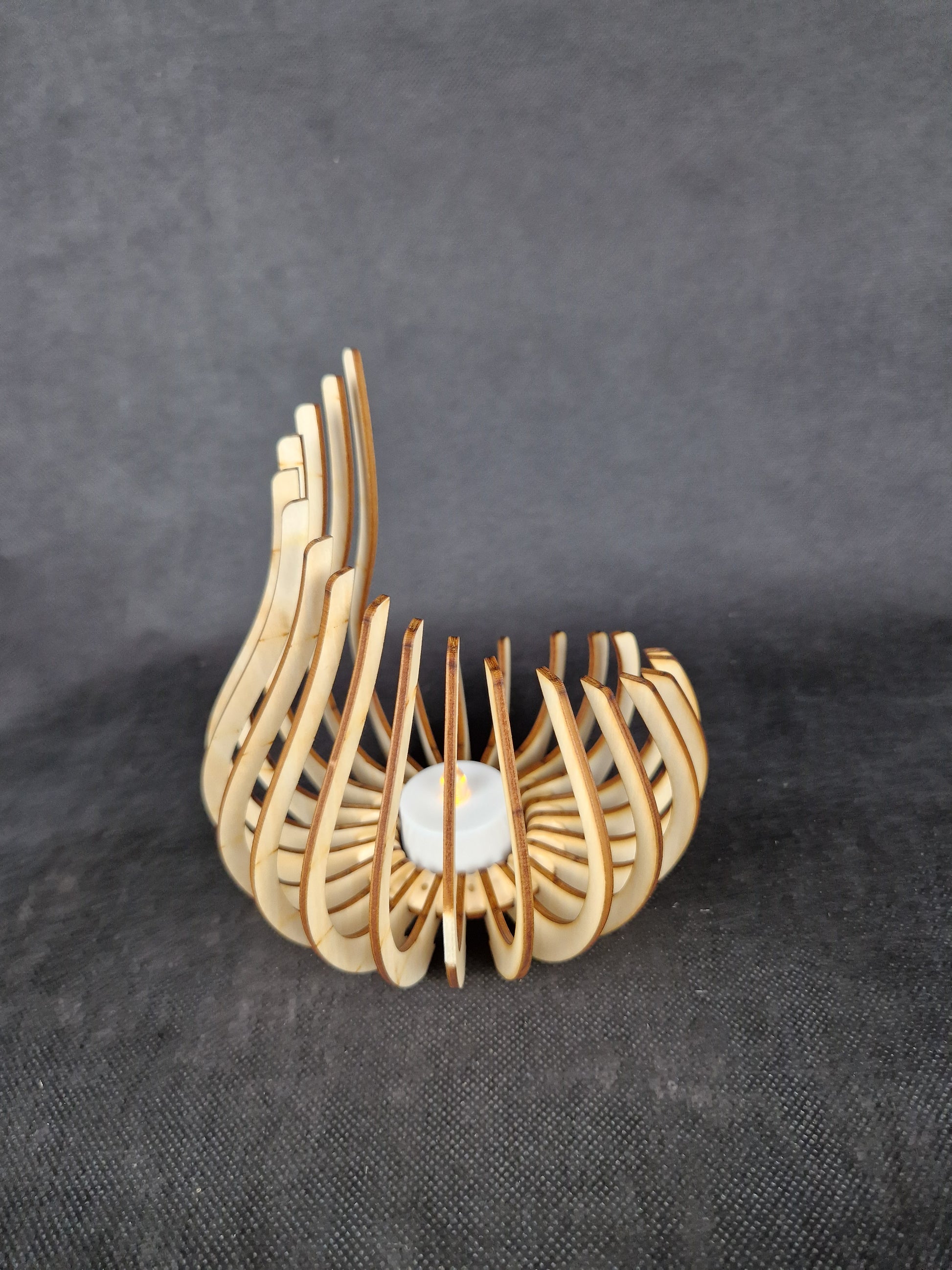 Modern geometric wooden tea light holder with intricate laser cut pattern creating light shadows