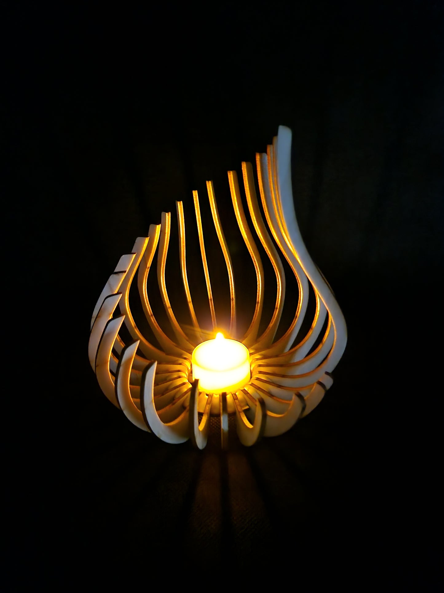 Modern geometric wooden tea light holder with intricate laser cut pattern creating light shadows