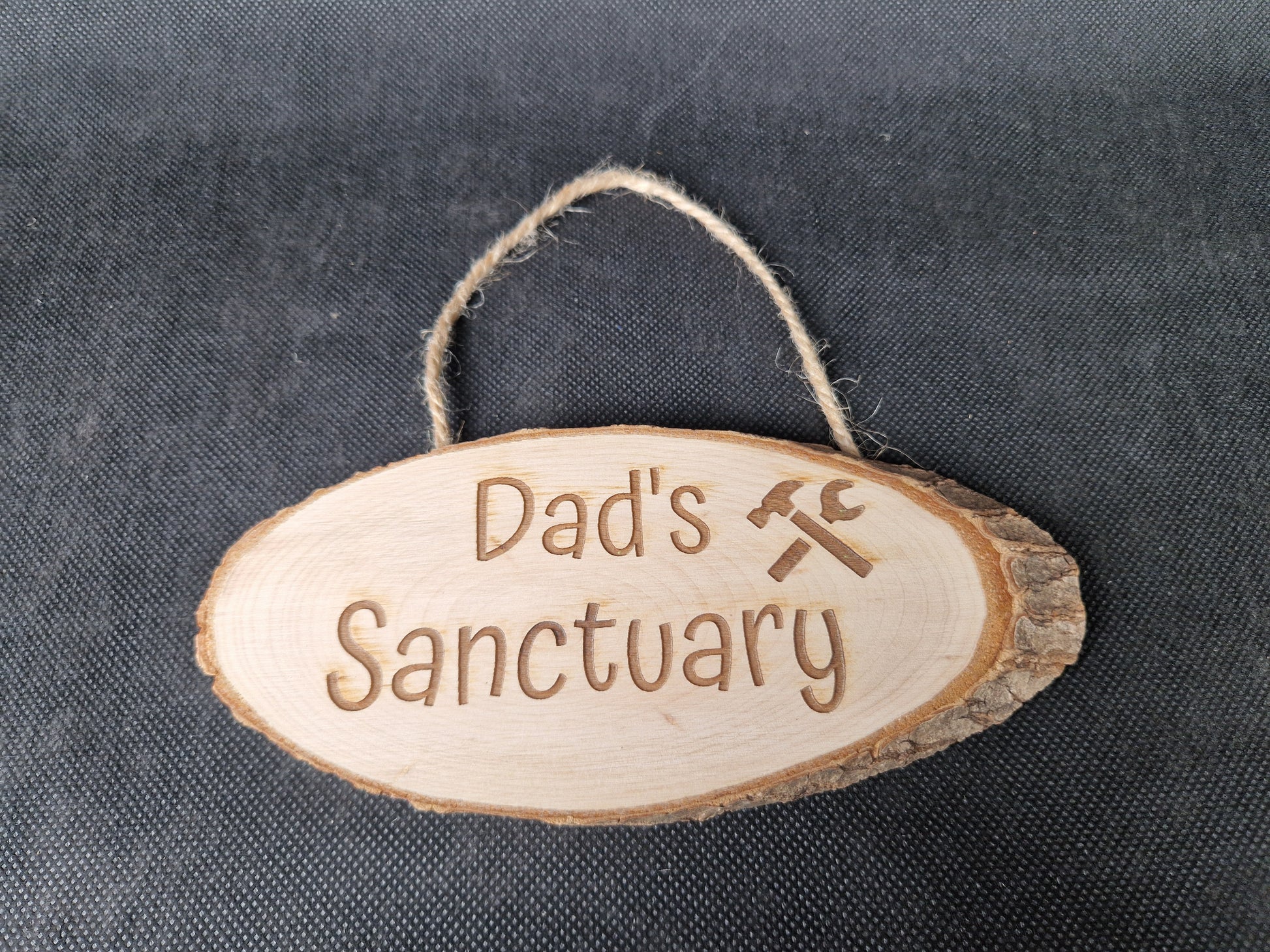 Natural wood slice hanging sign with rustic laser engraved text and jute rope hanger