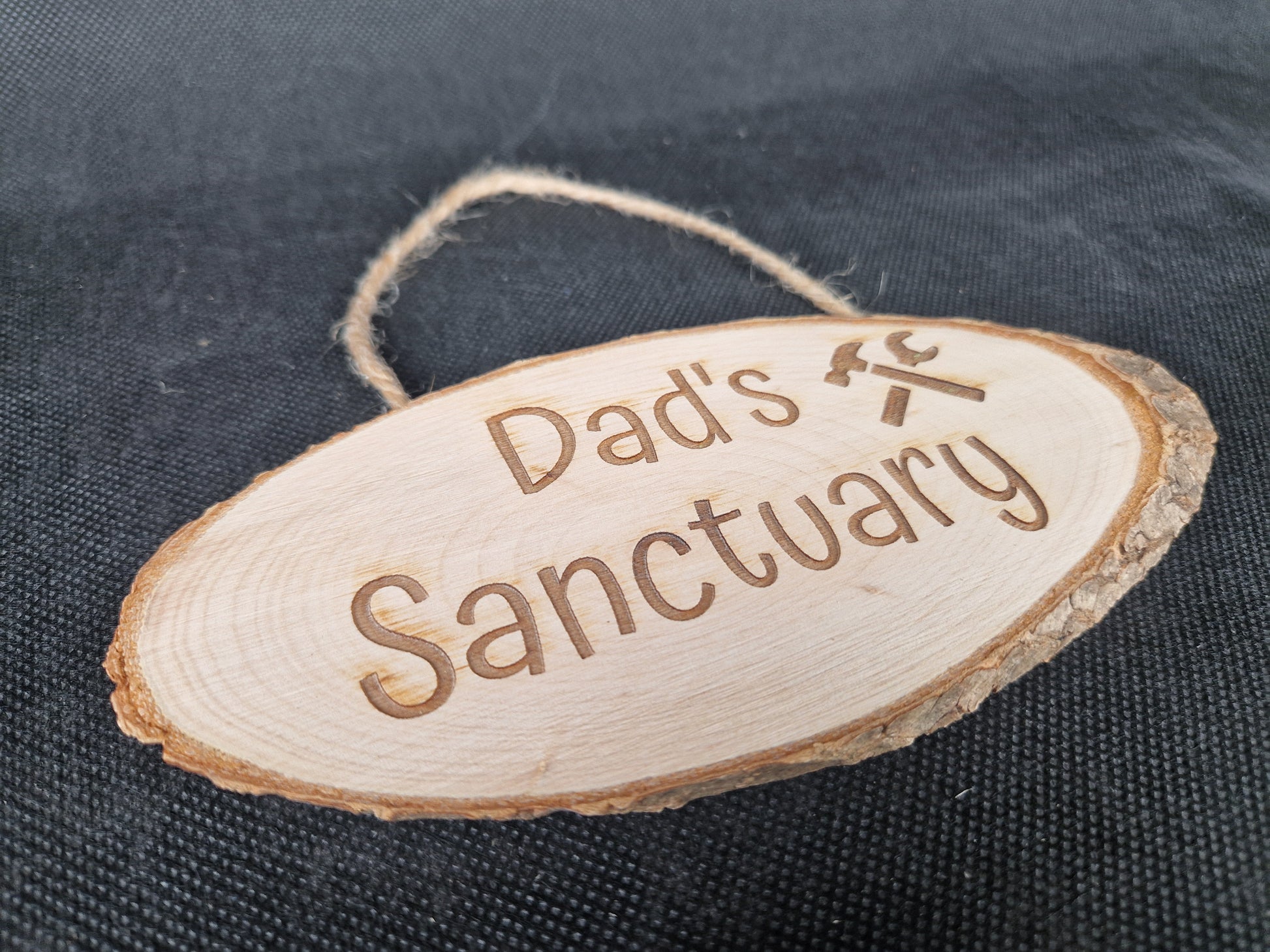 Natural wood slice hanging sign with rustic laser engraved text and jute rope hanger