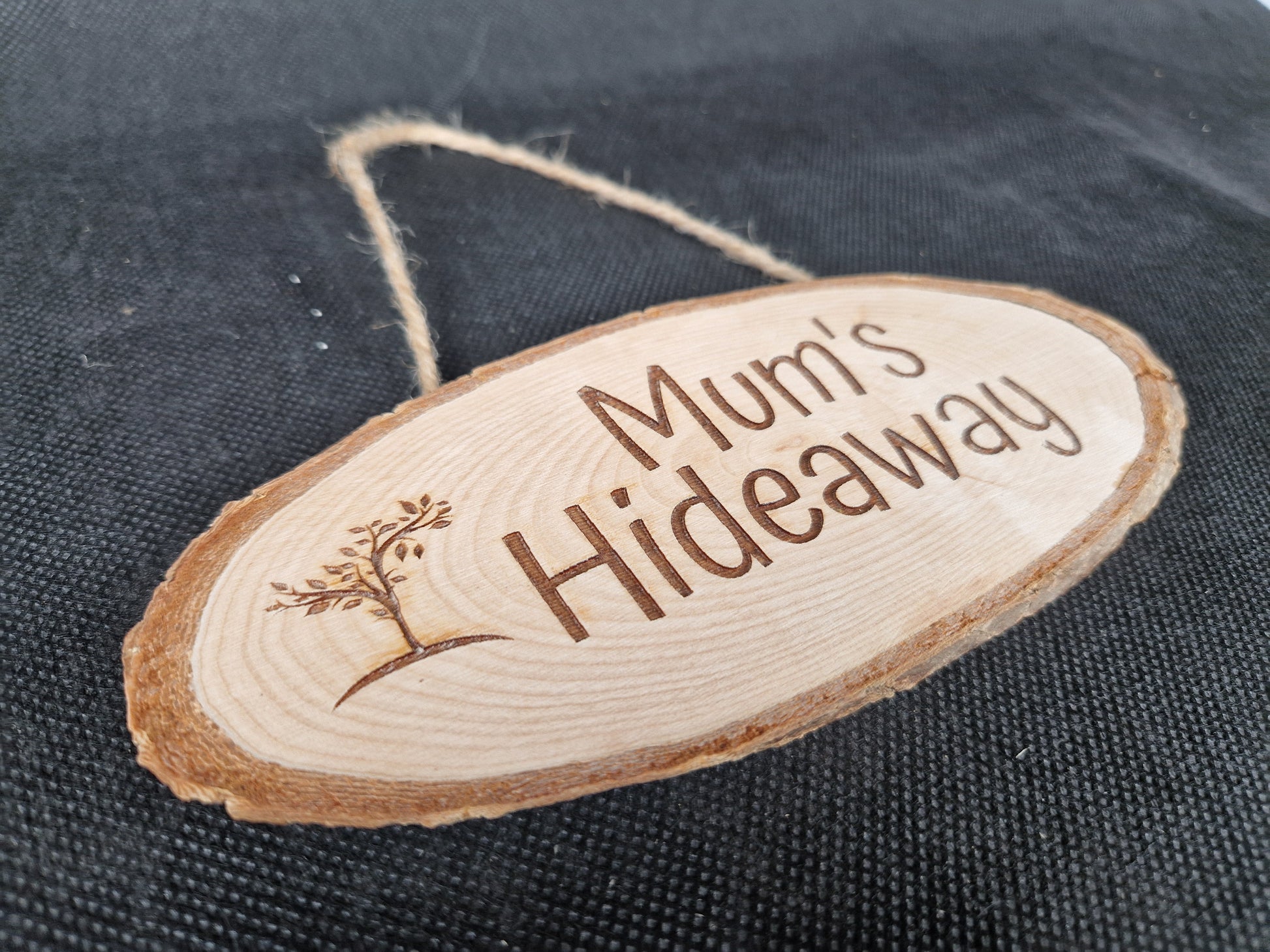 Natural wood slice hanging sign with rustic laser engraved text and jute rope hanger