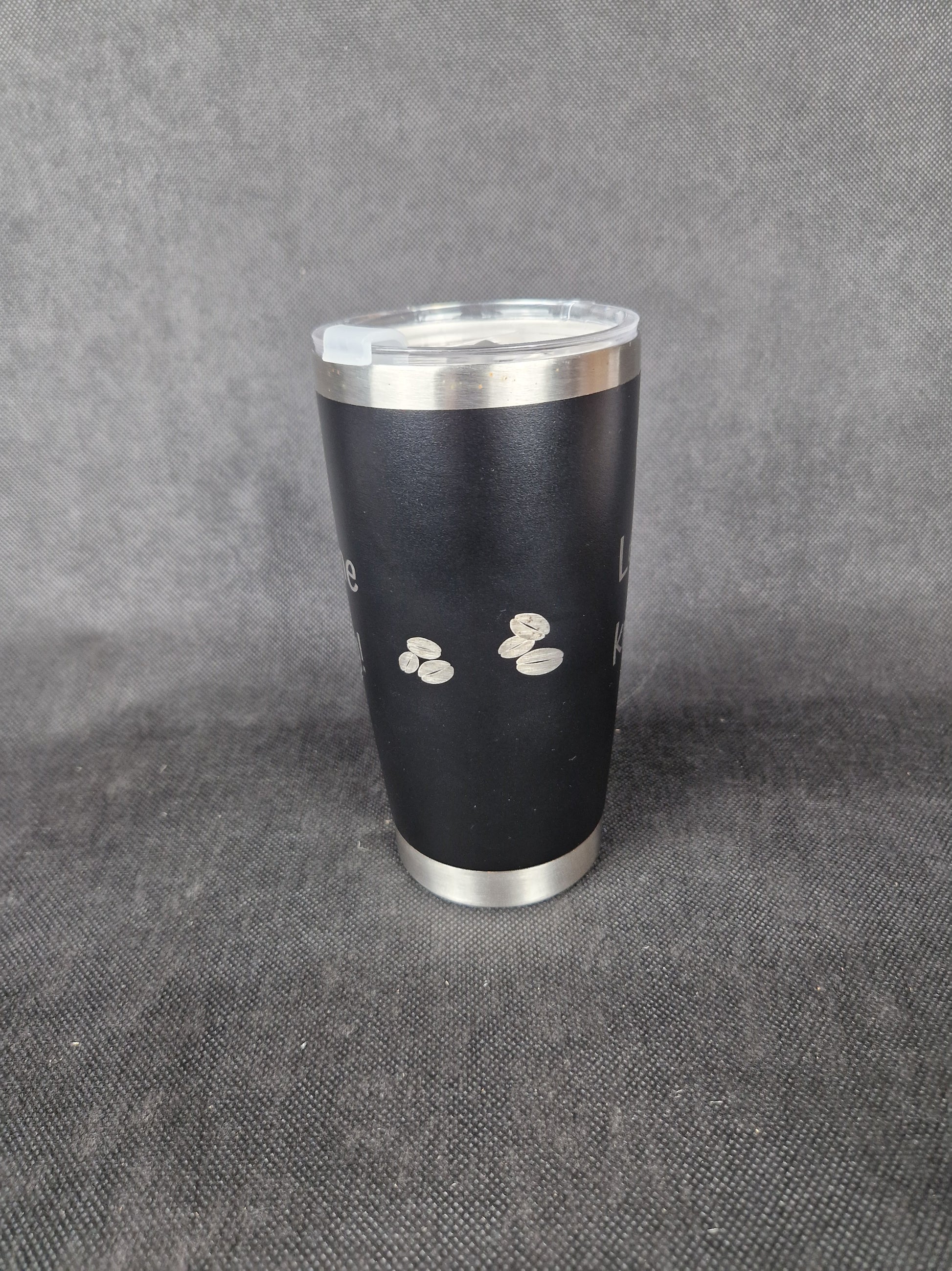 Stainless steel travel tumbler with custom laser engraved design and insulated walls