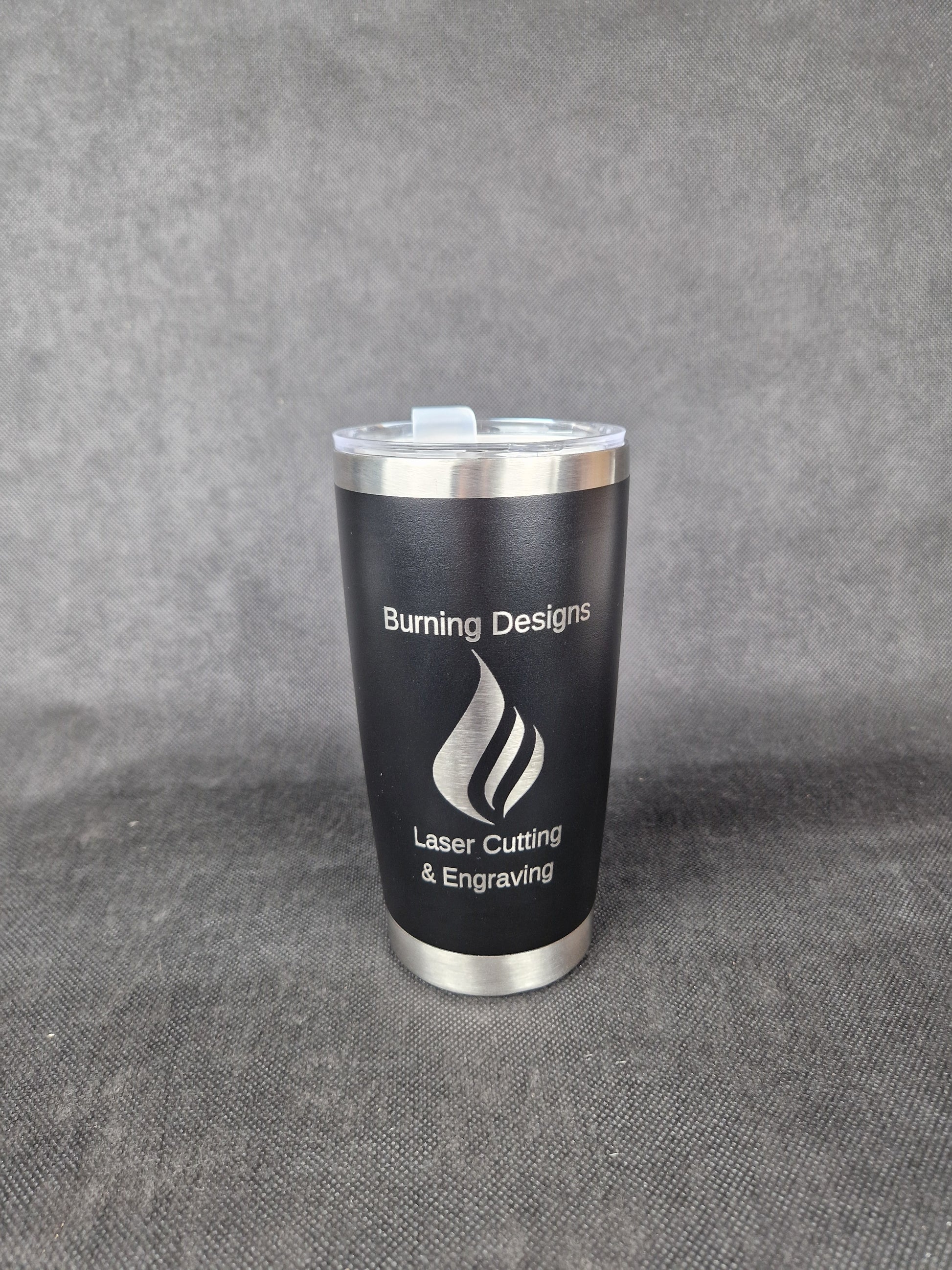 Stainless steel travel tumbler with custom laser engraved design and insulated walls