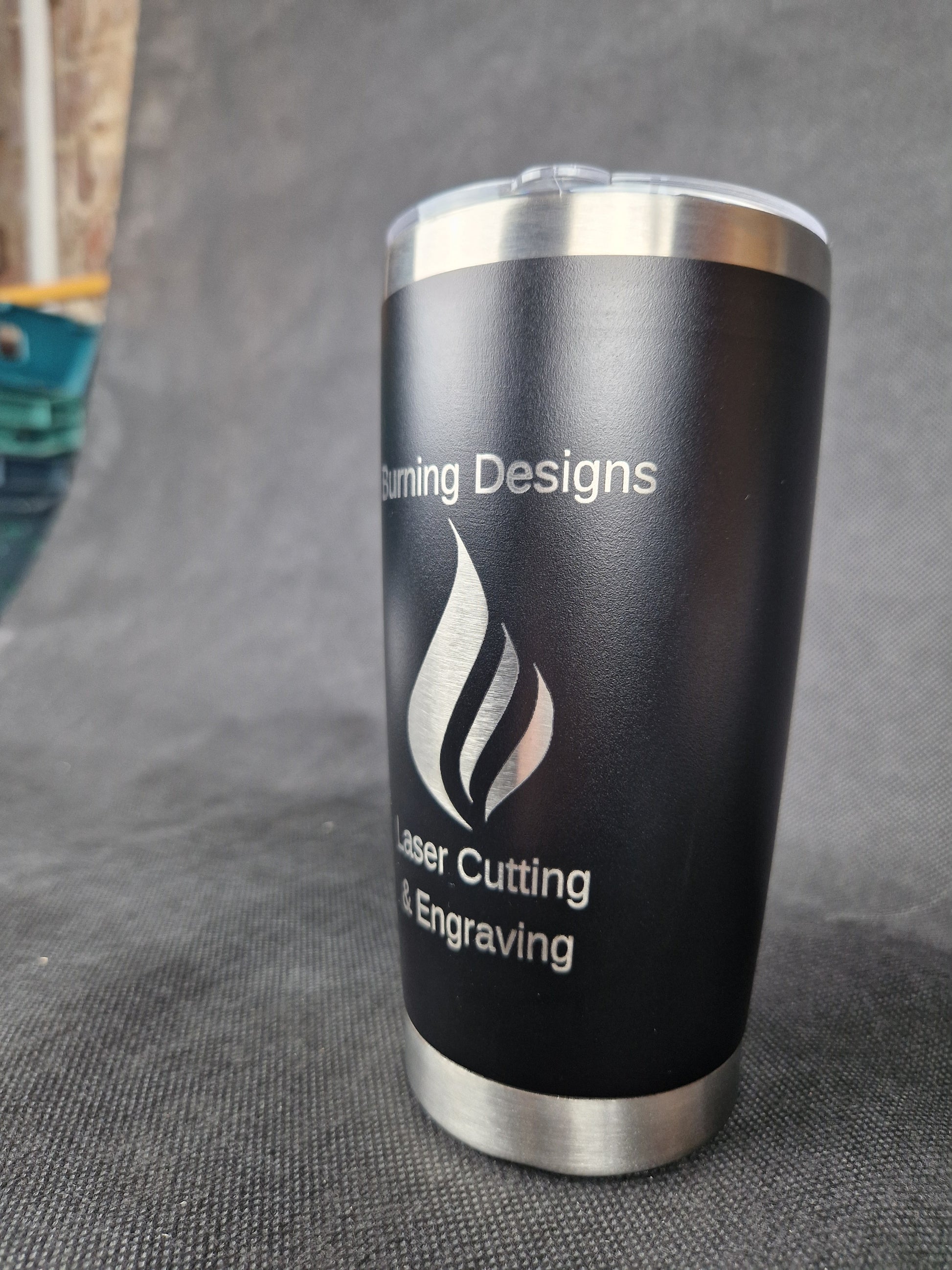 Stainless steel travel tumbler with custom laser engraved design and insulated walls