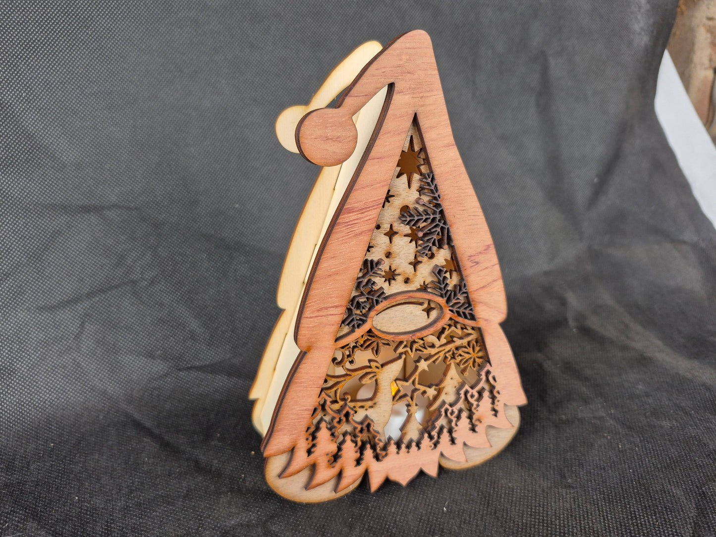 Illuminated wooden Gonk lamp with layered laser cut design and warm LED lighting