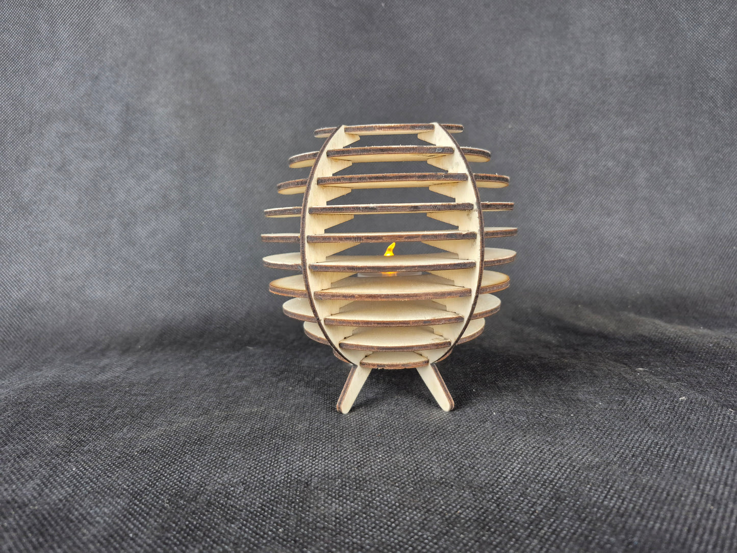 Spherical geometric tea light holder with intricate laser cut design and shadow effects