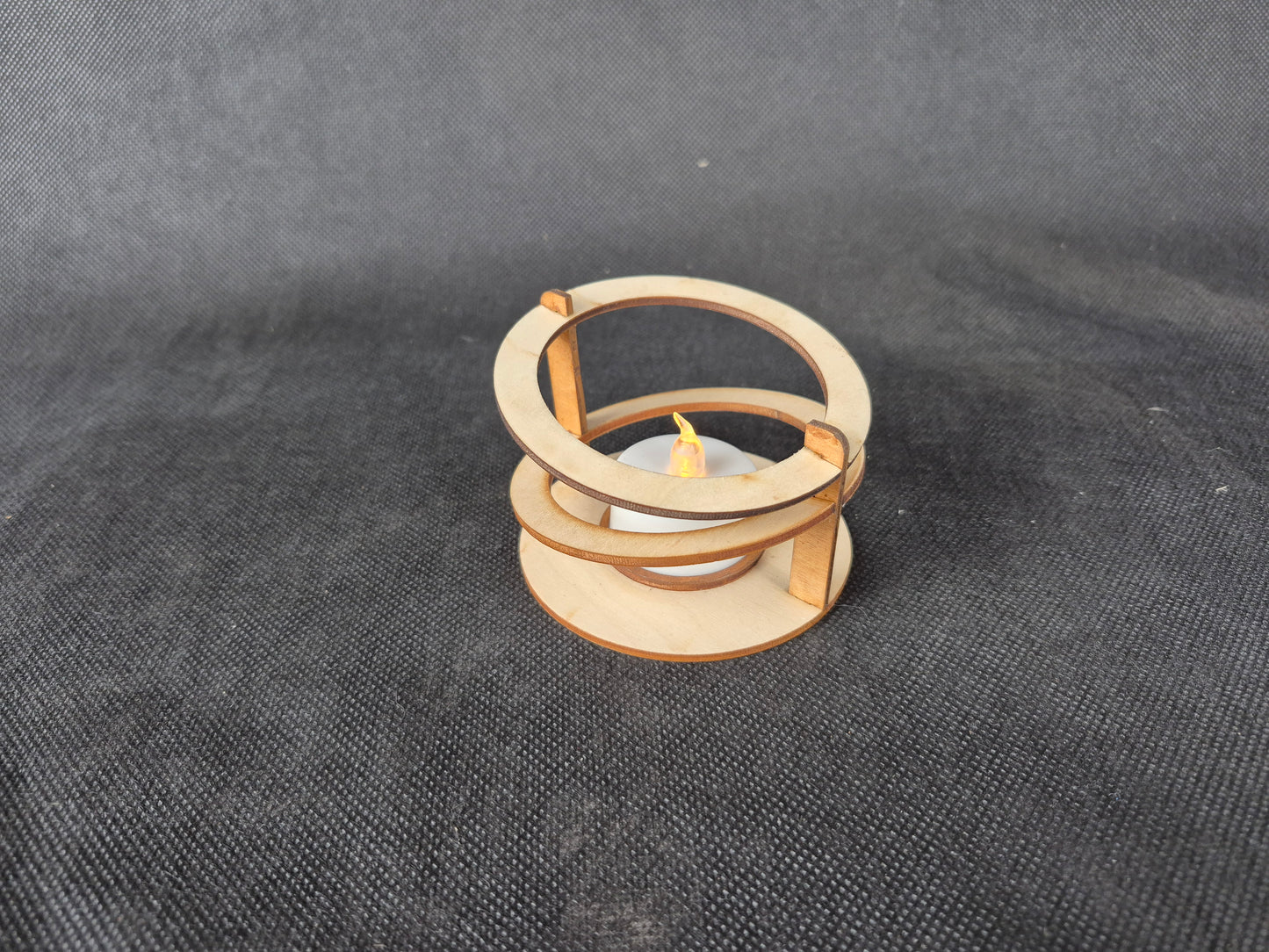 Modern ringed geometric tea light holder with intricate laser cut pattern and ambient lighting