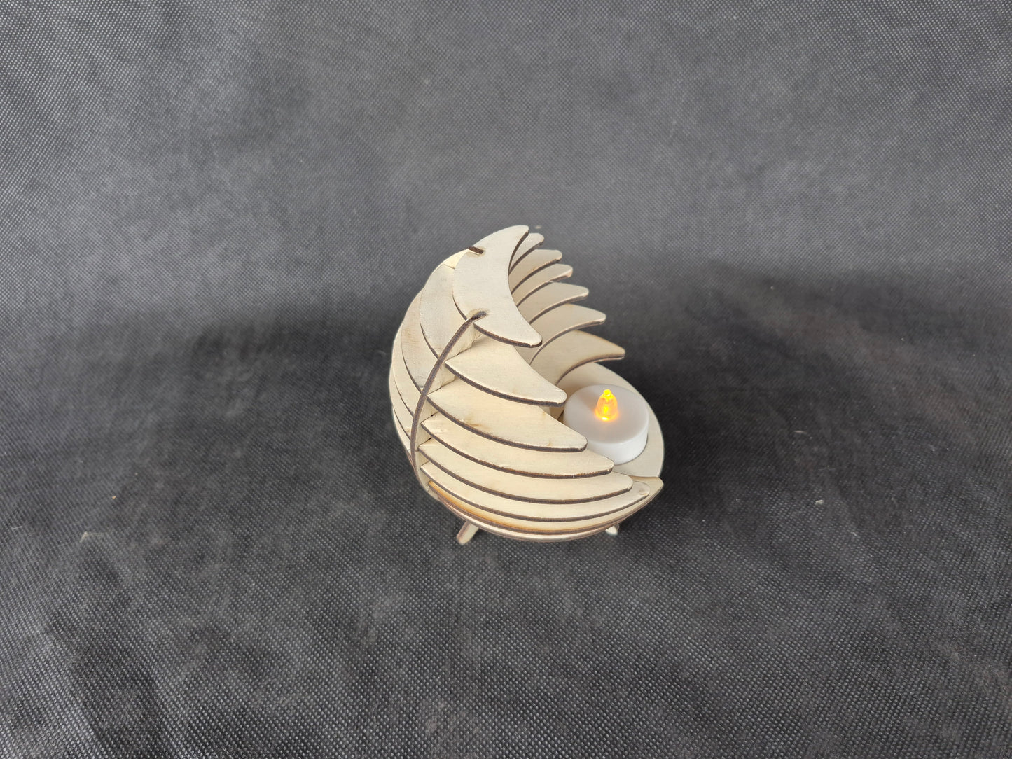 Spherical geometric tea light holder with intricate laser cut design and shadow effects