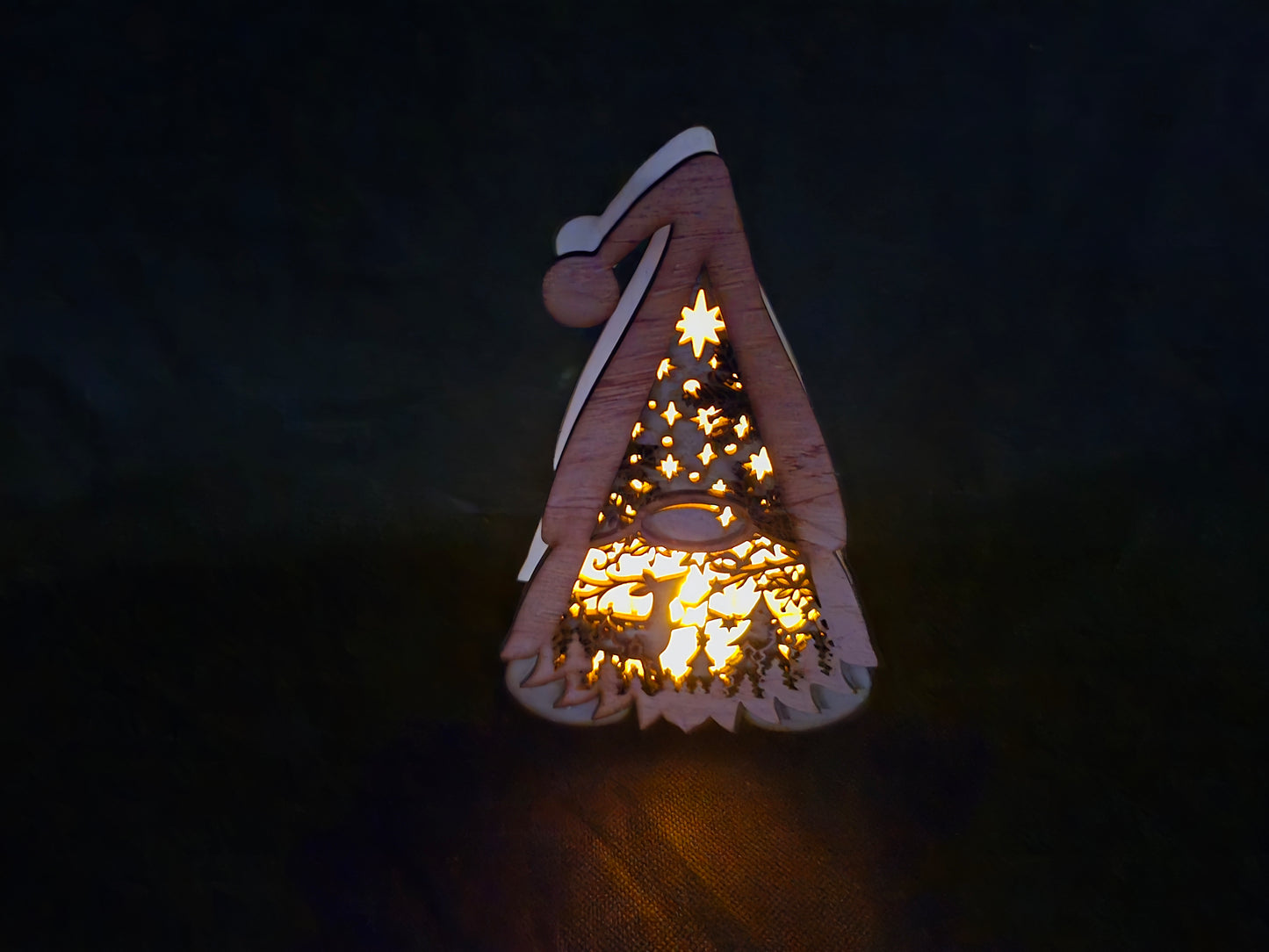 Illuminated wooden Gonk lamp with layered laser cut design and warm LED lighting