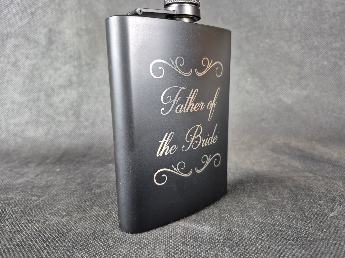 Stainless steel hip flask with personalized laser engraved message and brushed metal finish