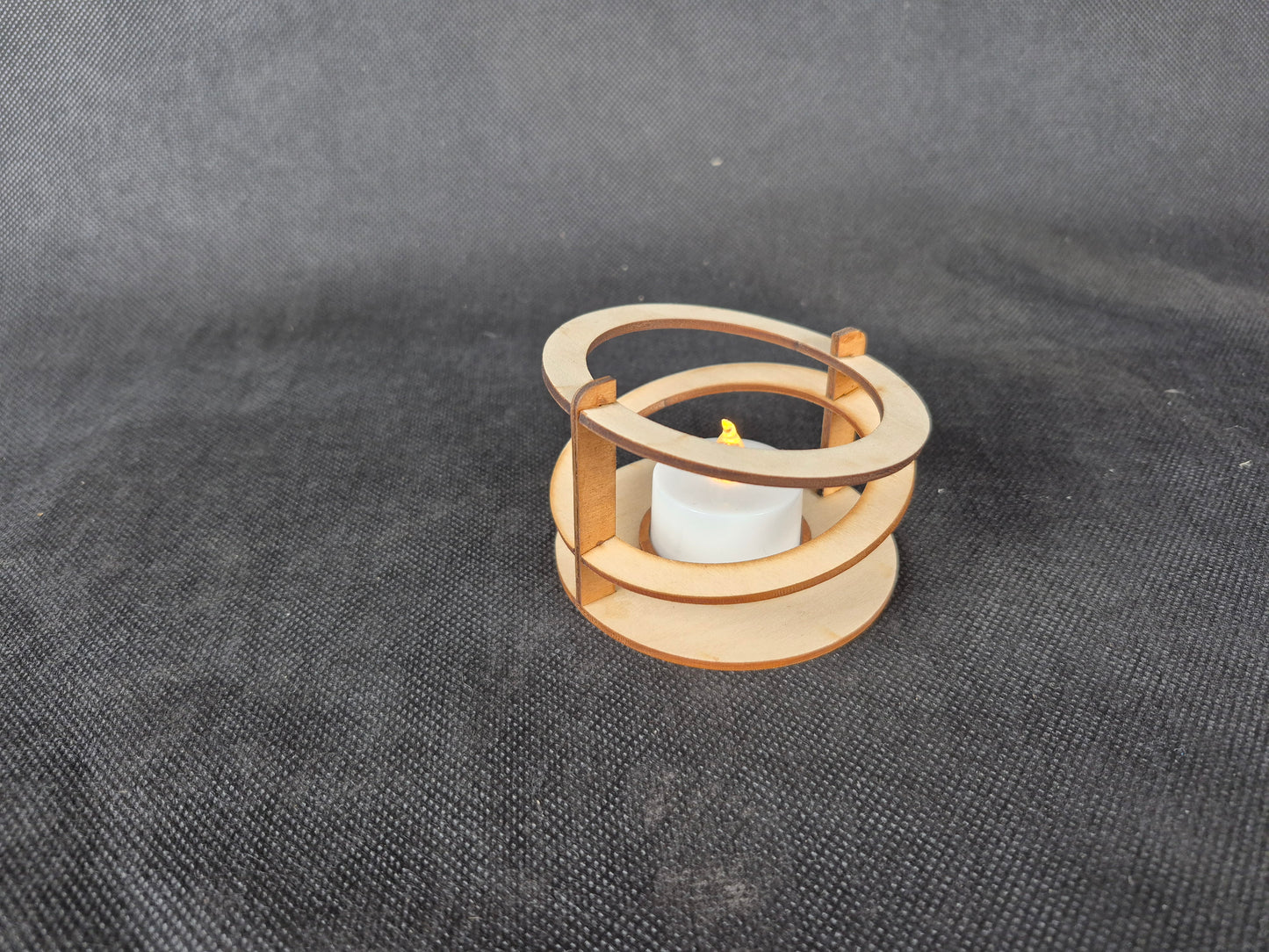 Modern ringed geometric tea light holder with intricate laser cut pattern and ambient lighting