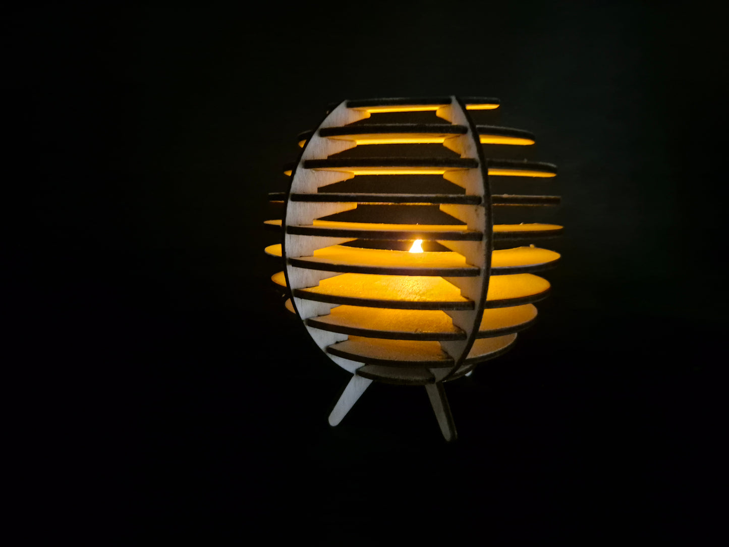 Spherical geometric tea light holder with intricate laser cut design and shadow effects