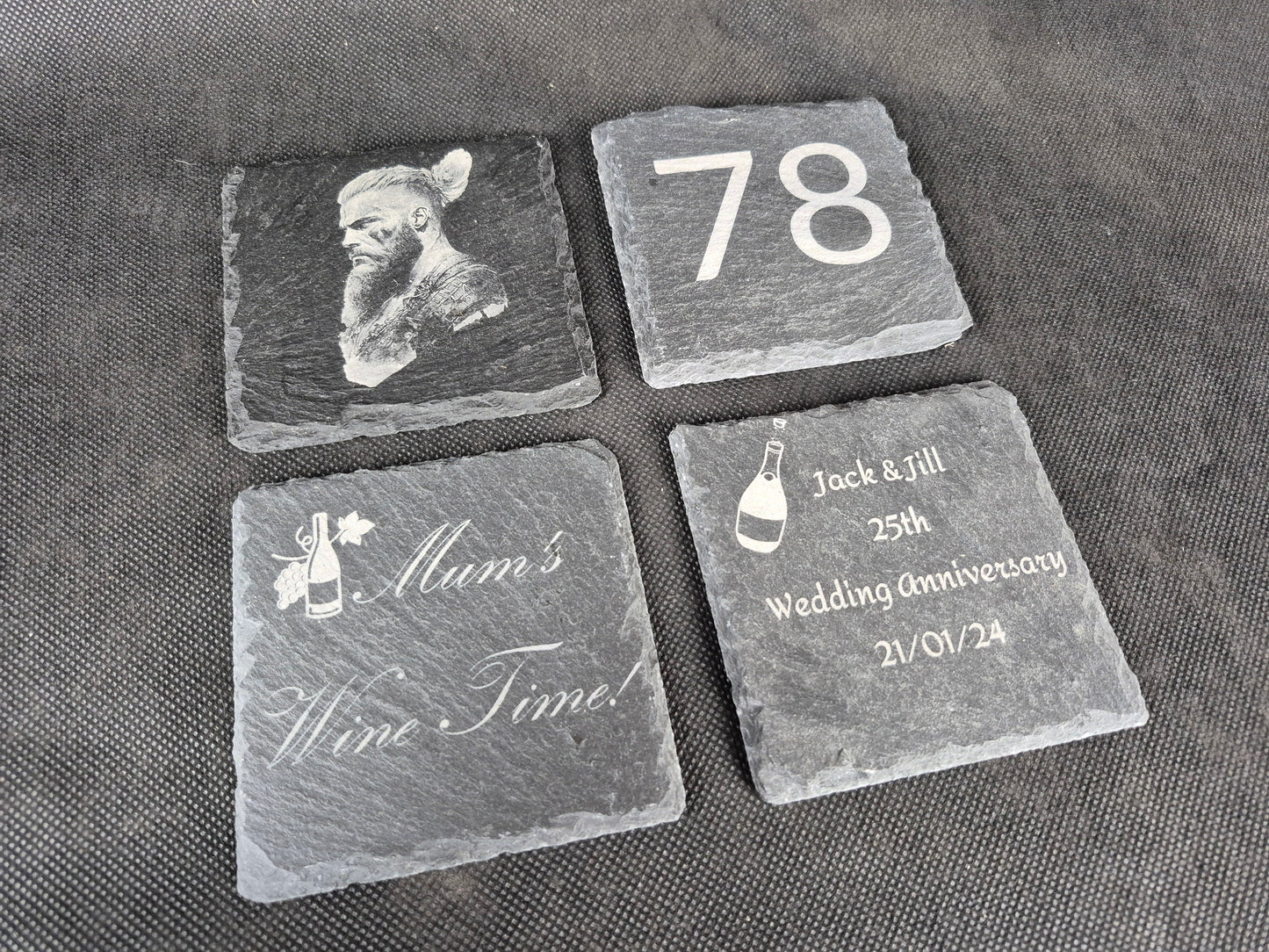Natural black slate drink coaster with custom laser engraved design and protective feet