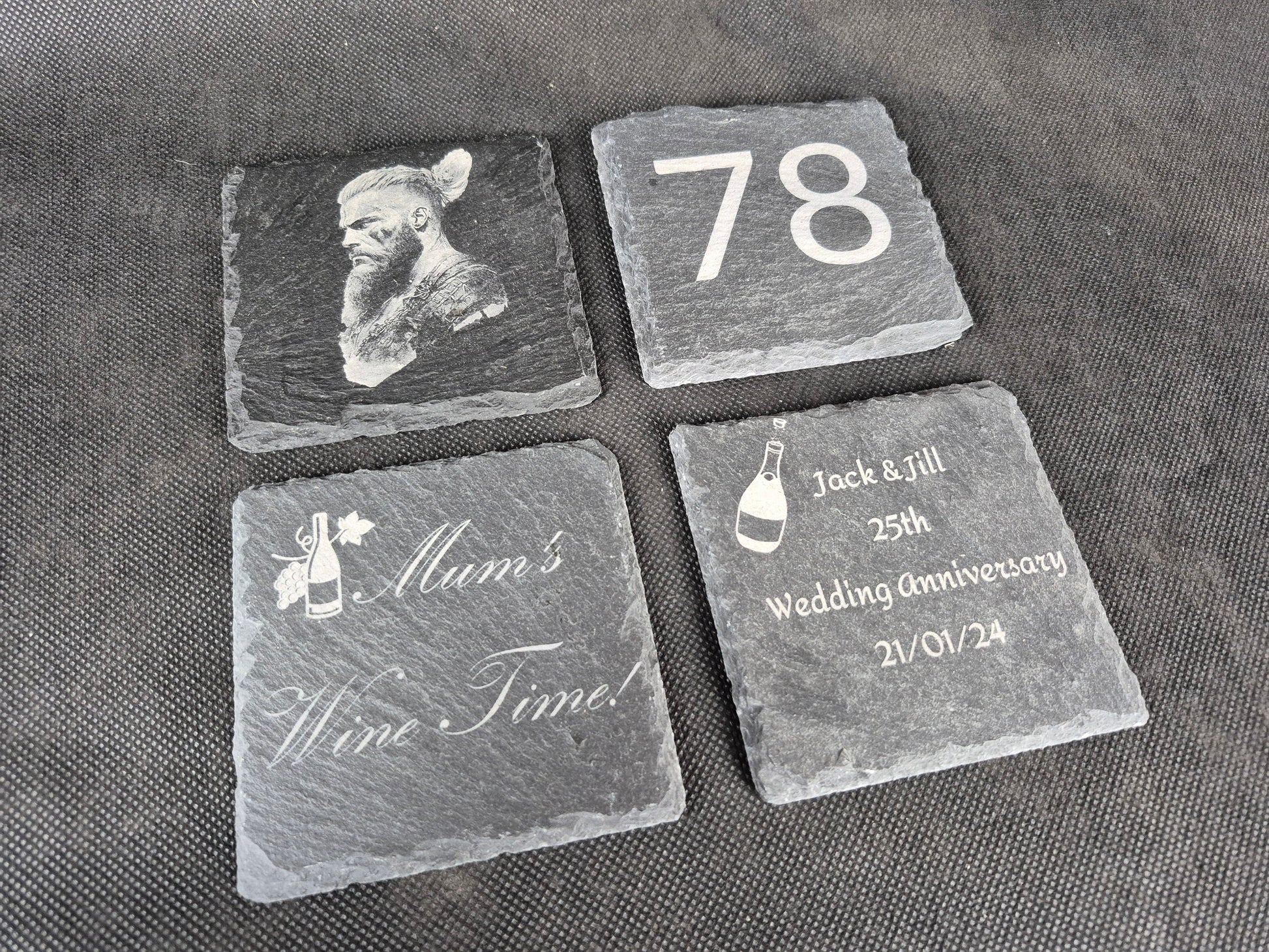 Natural black slate drink coaster with custom laser engraved design and protective feet