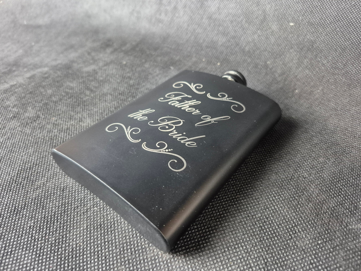 Stainless steel hip flask with personalized laser engraved message and brushed metal finish
