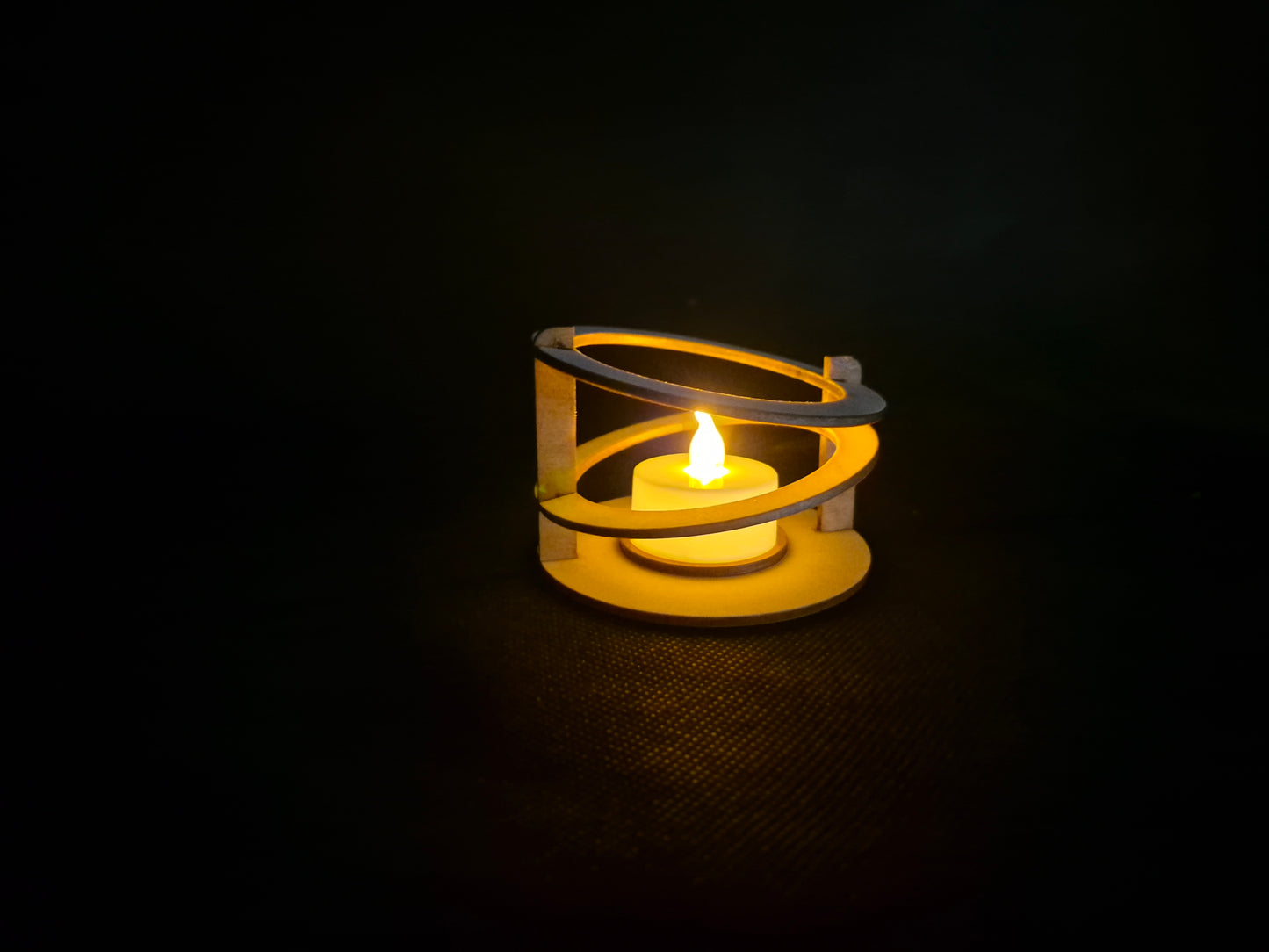 Modern ringed geometric tea light holder with intricate laser cut pattern and ambient lighting