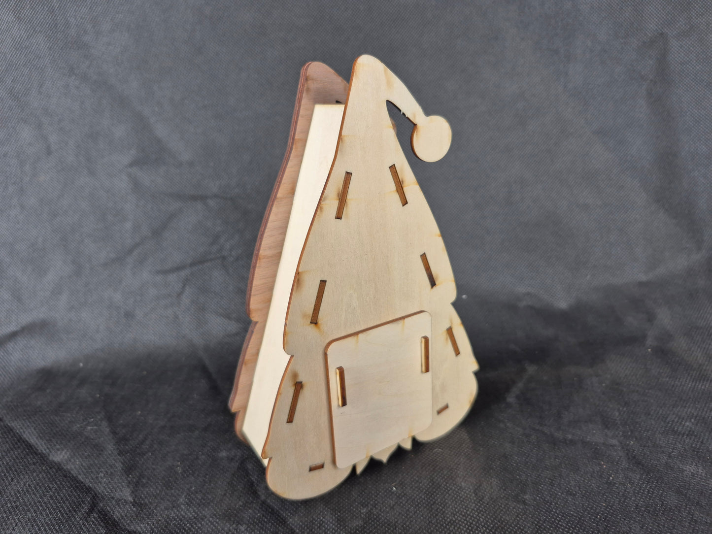 Illuminated wooden Gonk lamp with layered laser cut design and warm LED lighting