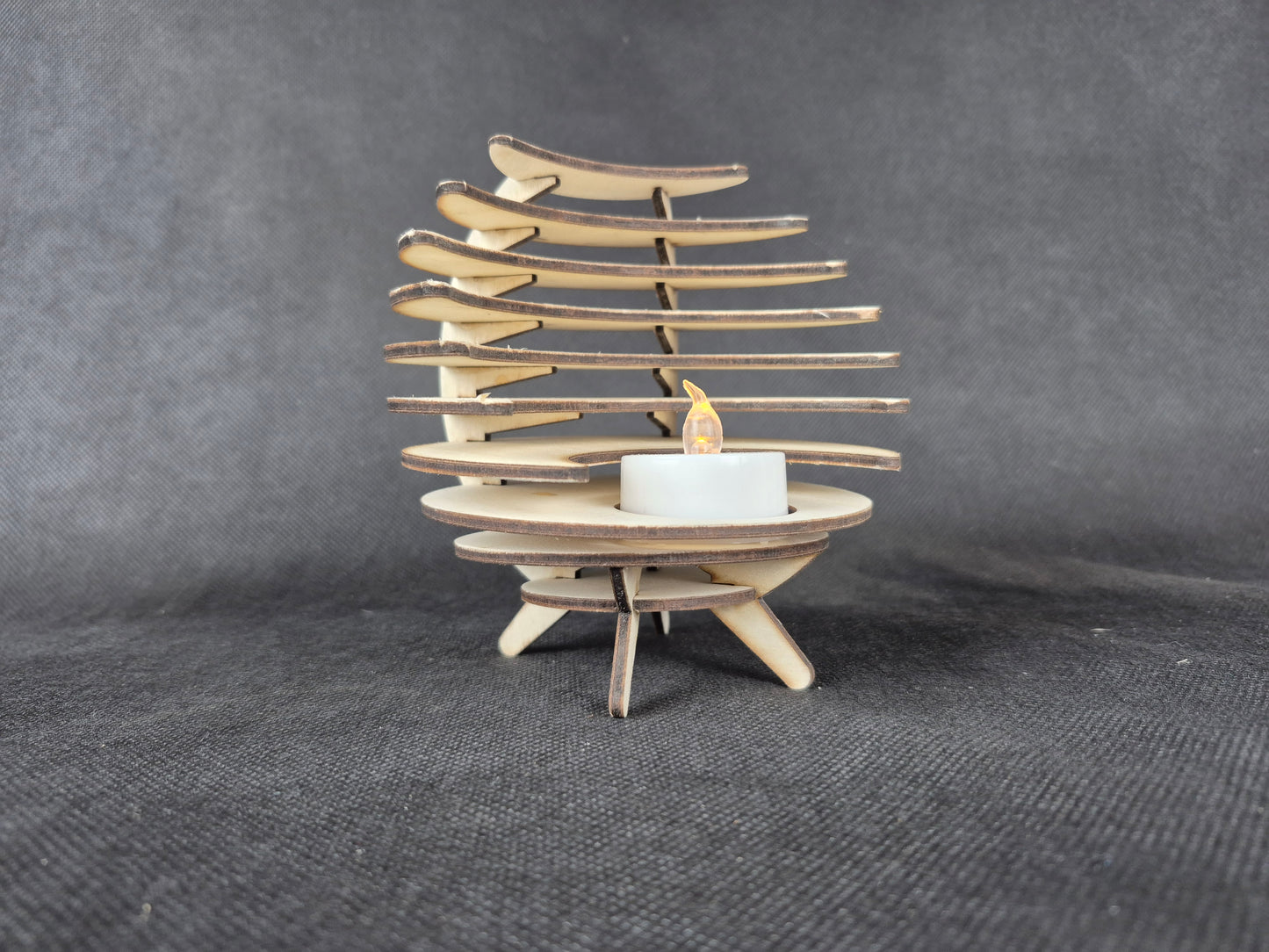 Spherical geometric tea light holder with intricate laser cut design and shadow effects