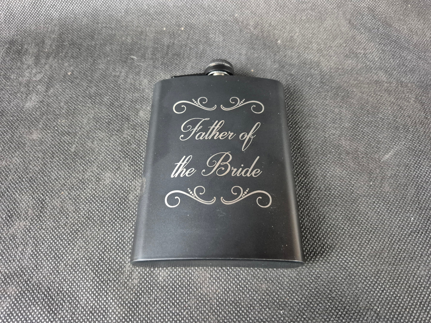 Stainless steel hip flask with personalized laser engraved message and brushed metal finish