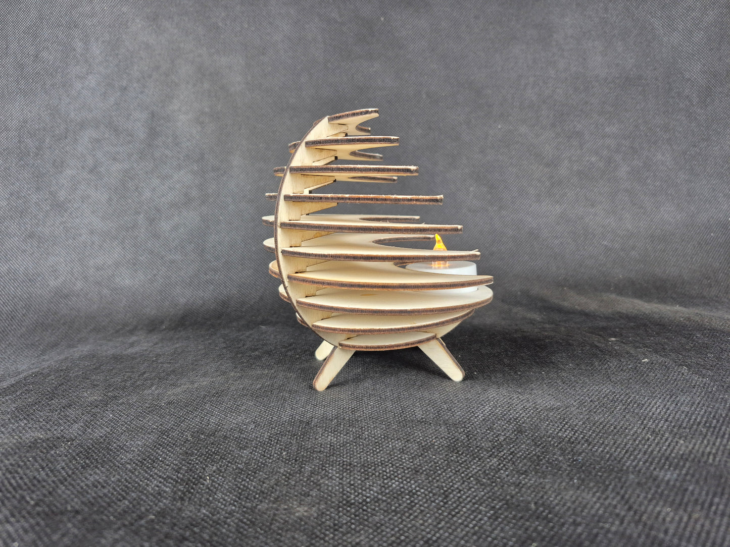 Spherical geometric tea light holder with intricate laser cut design and shadow effects