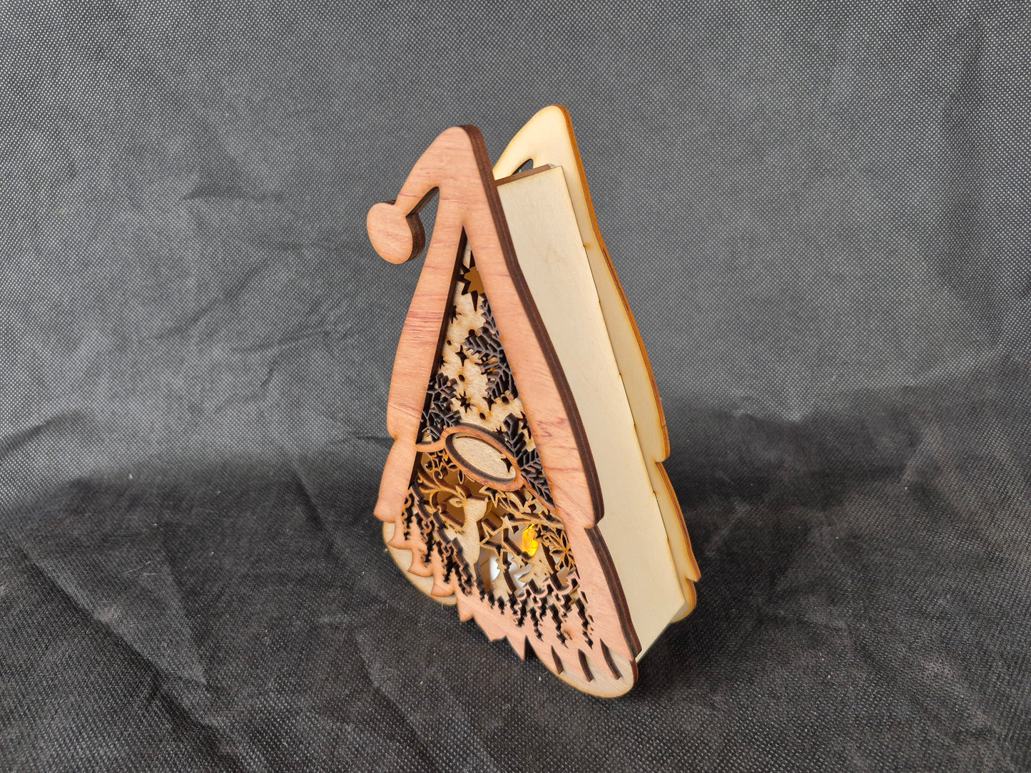 Illuminated wooden Gonk lamp with layered laser cut design and warm LED lighting