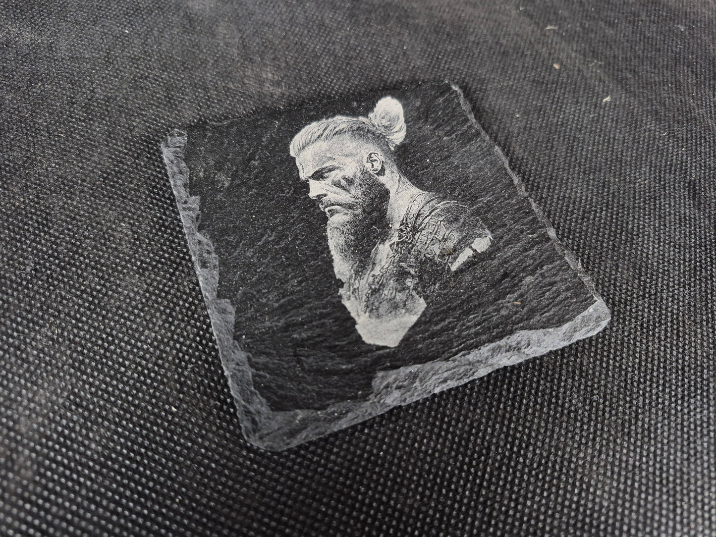 Natural black slate drink coaster with custom laser engraved design and protective feet