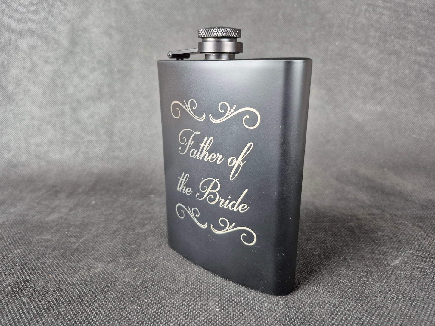 Stainless steel hip flask with personalized laser engraved message and brushed metal finish