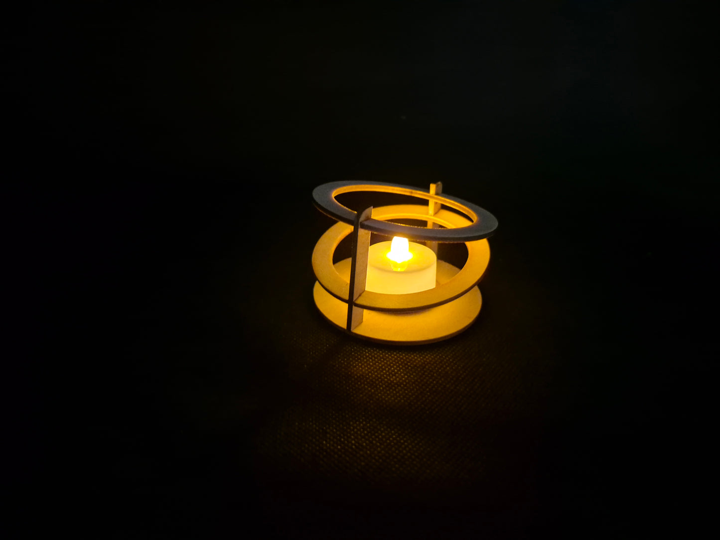 Modern ringed geometric tea light holder with intricate laser cut pattern and ambient lighting